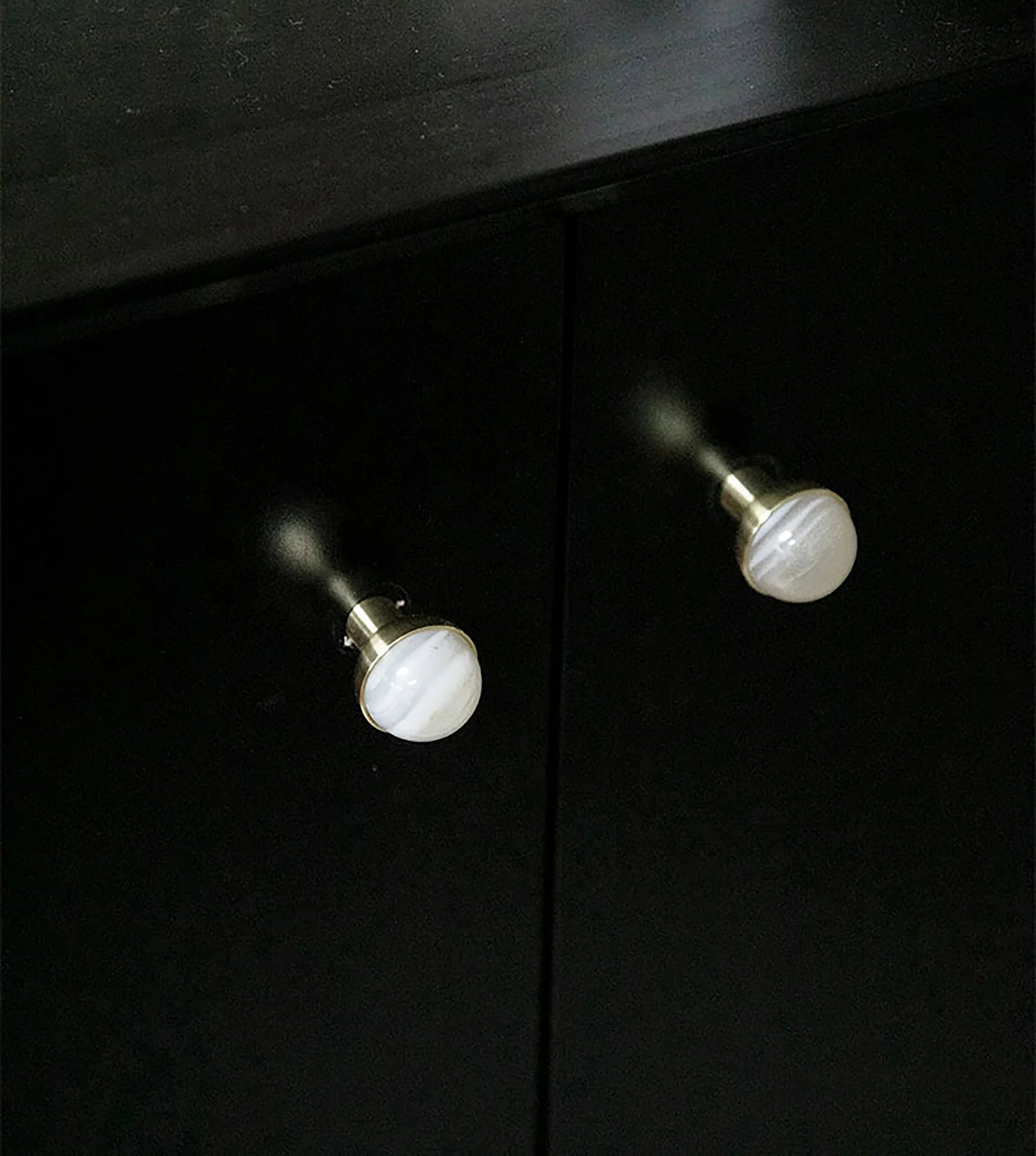 The Mantara C-0006 is a modern crystal + brass knob in white, ideal for drawers and cabinets.
