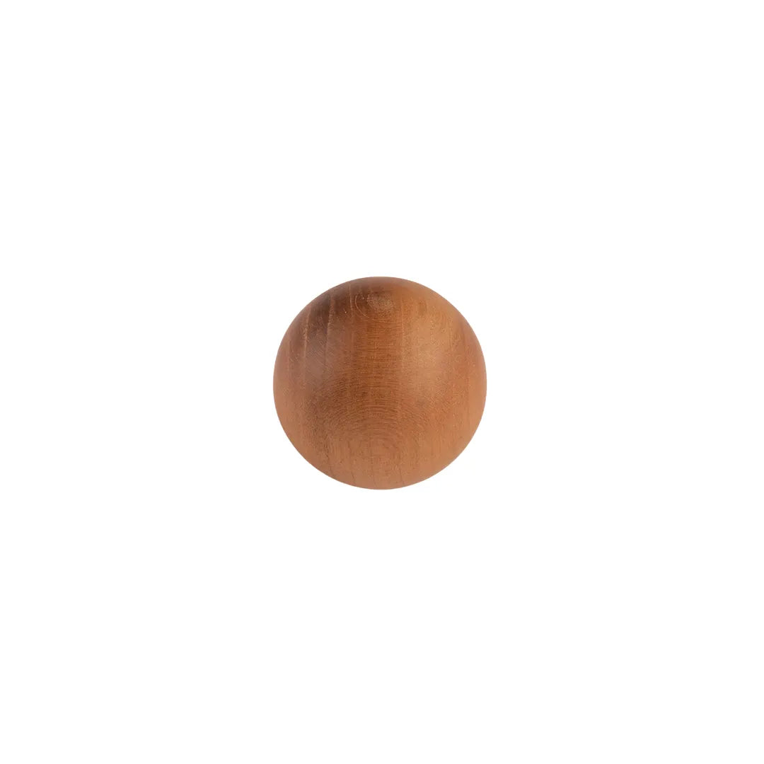 A single round wooden knob or ball-shaped furniture accent in a warm medium brown wood finish, centered on a plain white background.