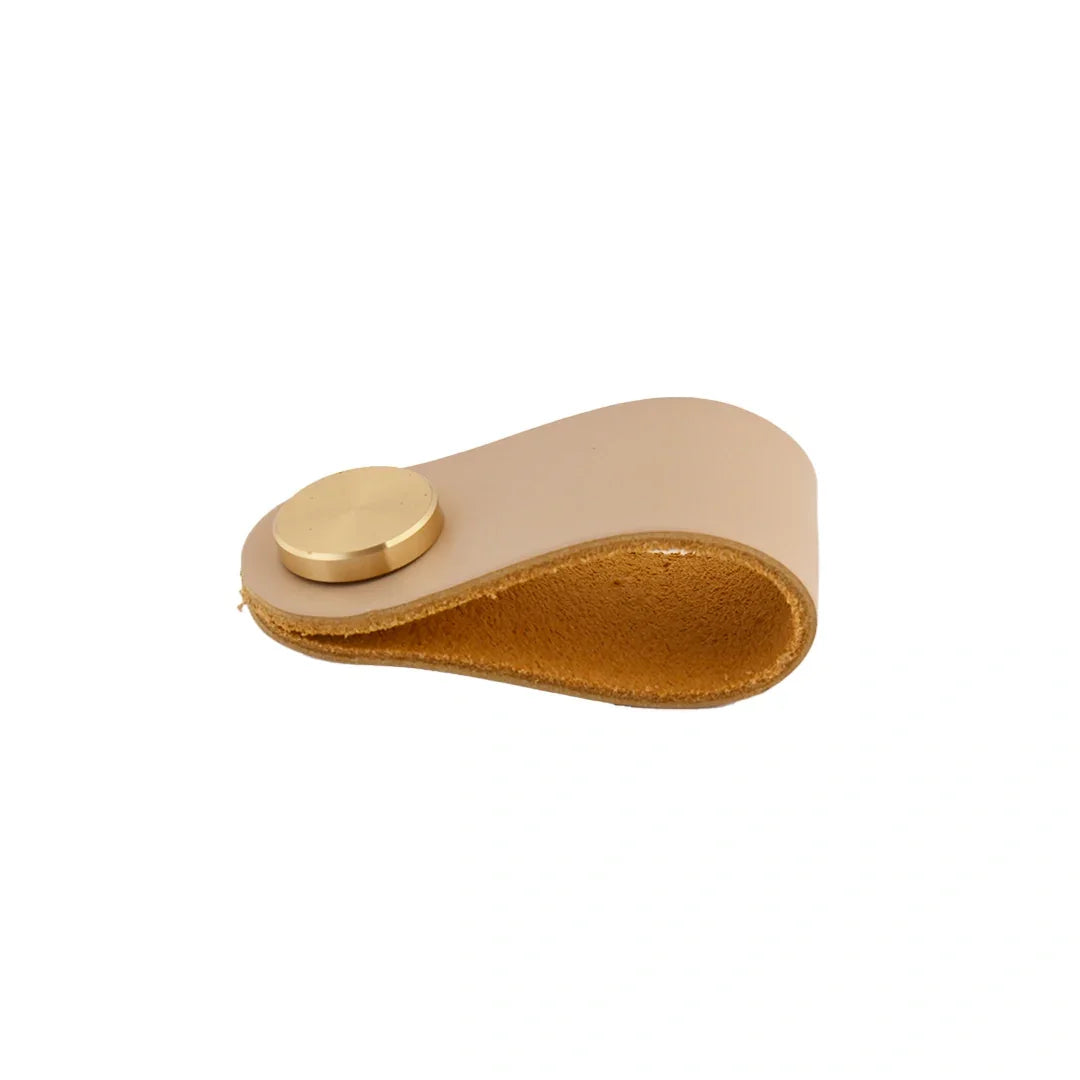 The Mantara L-0001 Maverick Pull Knob is a Nordic leather and brass knob in cream, ideal for kitchens and furniture.