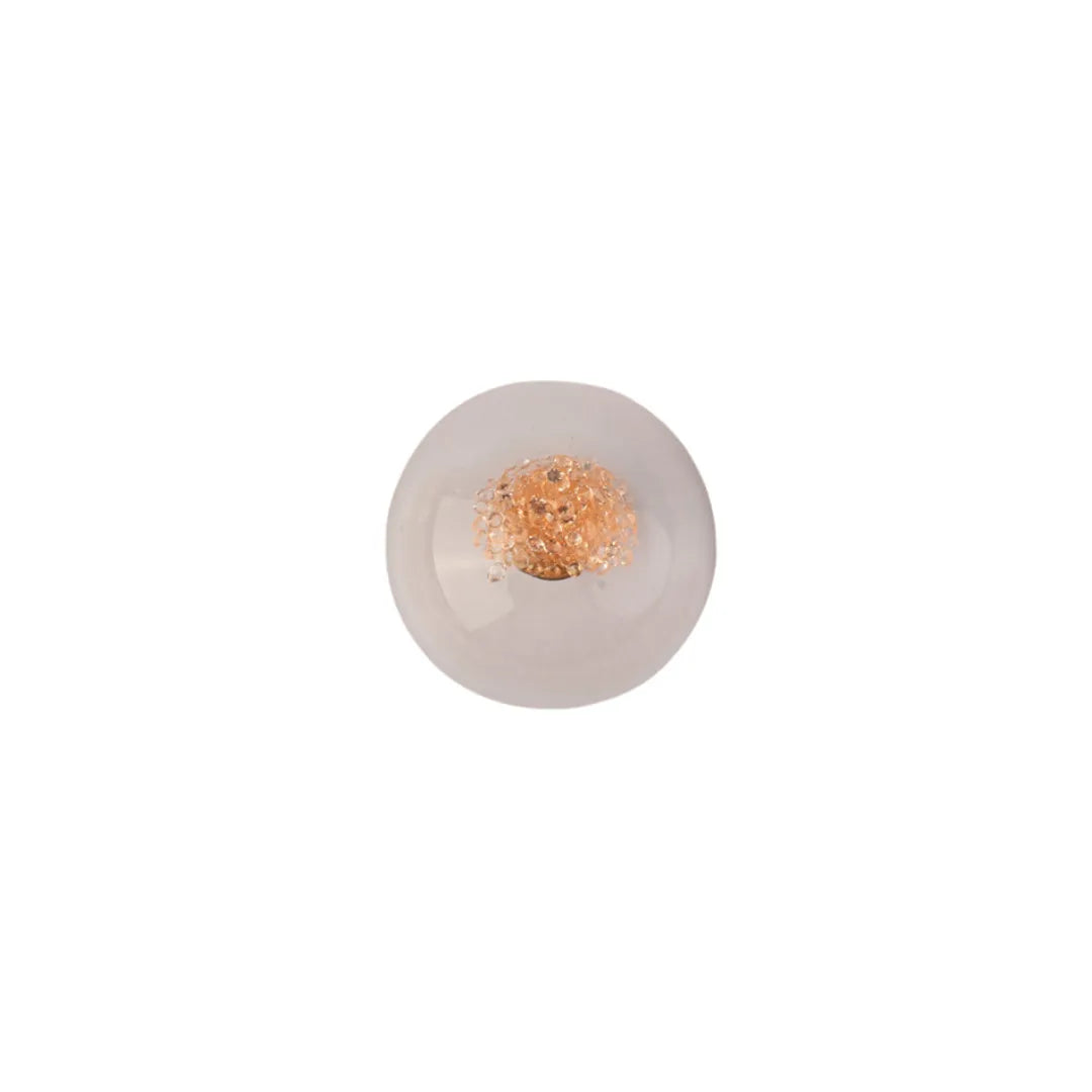 A single round, translucent frosted glass or acrylic wall light with a textured metallic gold center, shown against a solid white background.