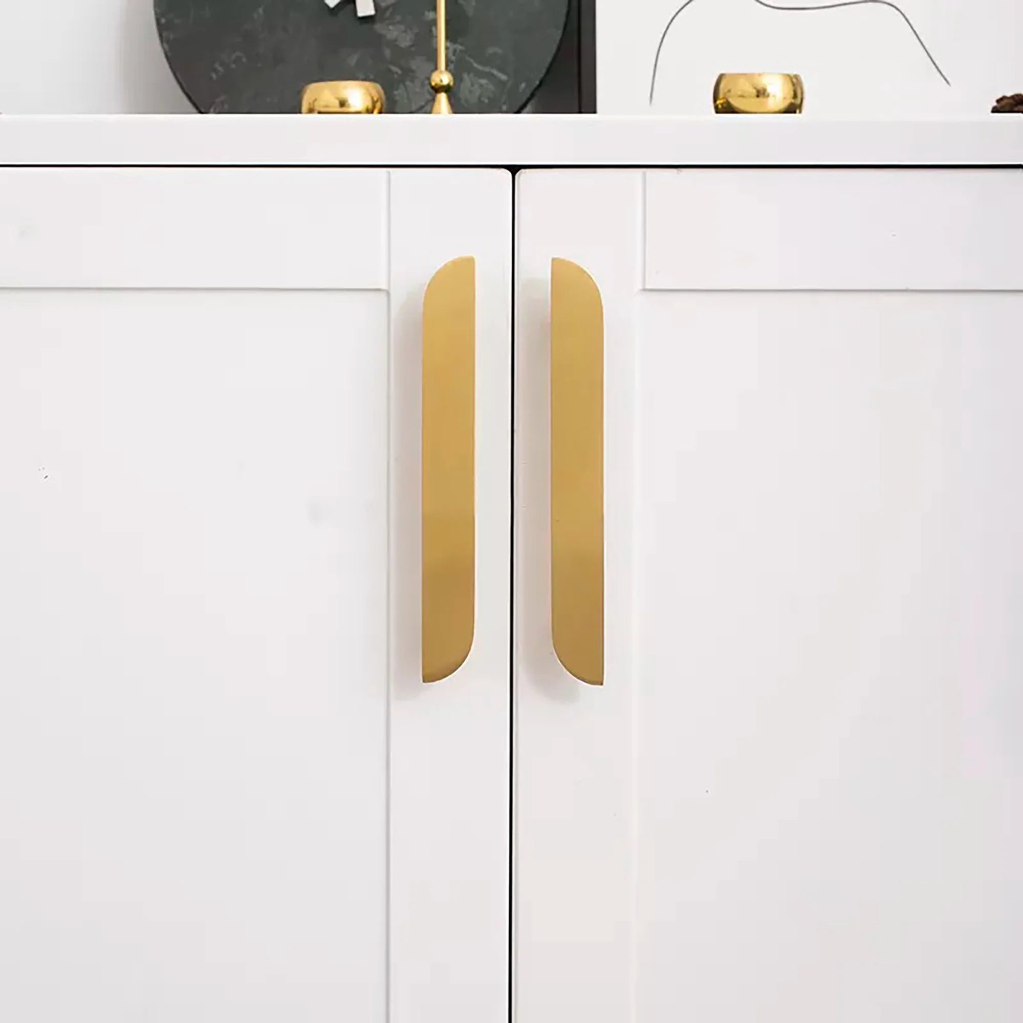 The Tarang hanlde by Mantara (B-0104) is a brushed brass modern pair knob in gold, perfect for wardrobes, doors, and kitchens.