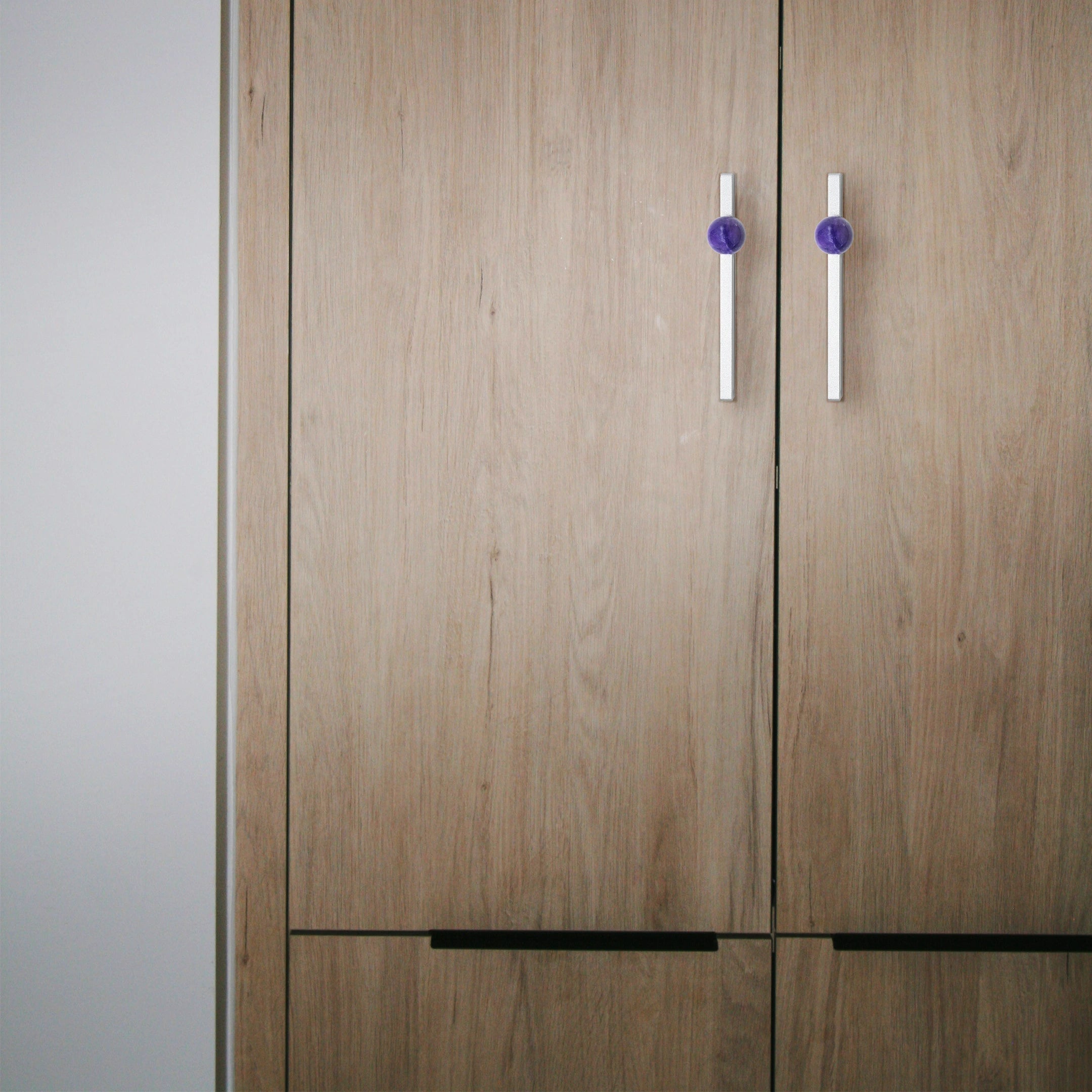 Wooden wardrobe with two doors and two handles on a neutral background