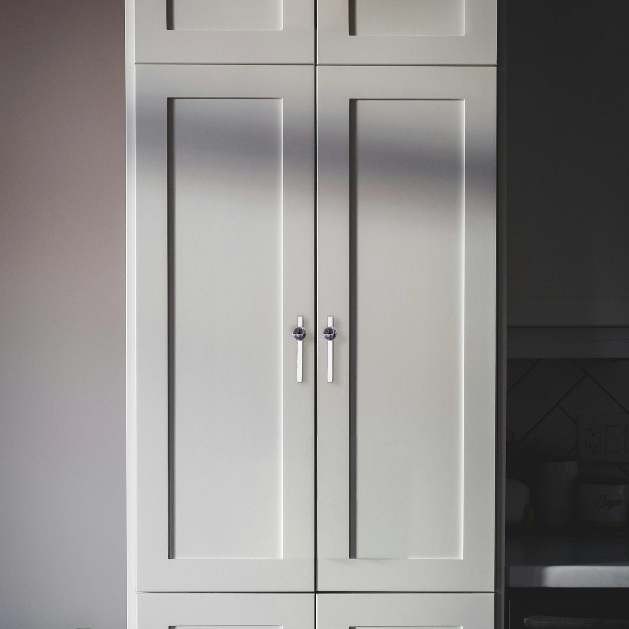 Gray kitchen cabinets with clean lines shown in focus, set against a softly blurred background, styled by Mantara.