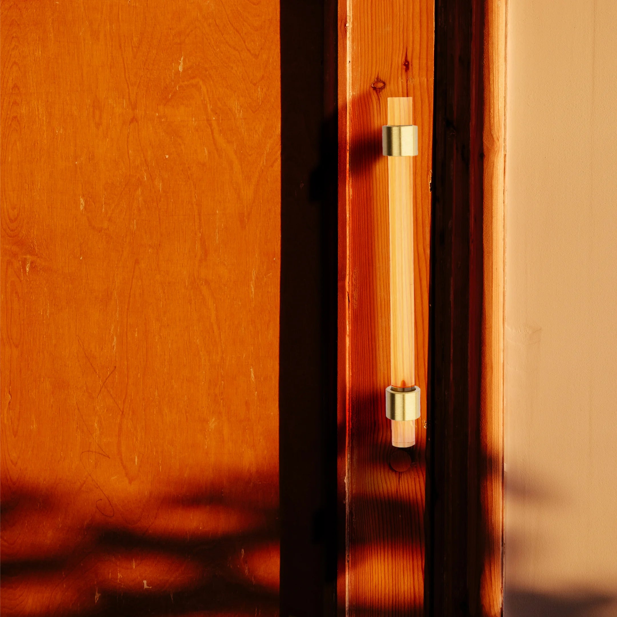 A stylish T-bar cabinet handle, Petra I made of clear acrylic and brushed brass in dark brown finish, model A-0007 by Mantara, A-0007.