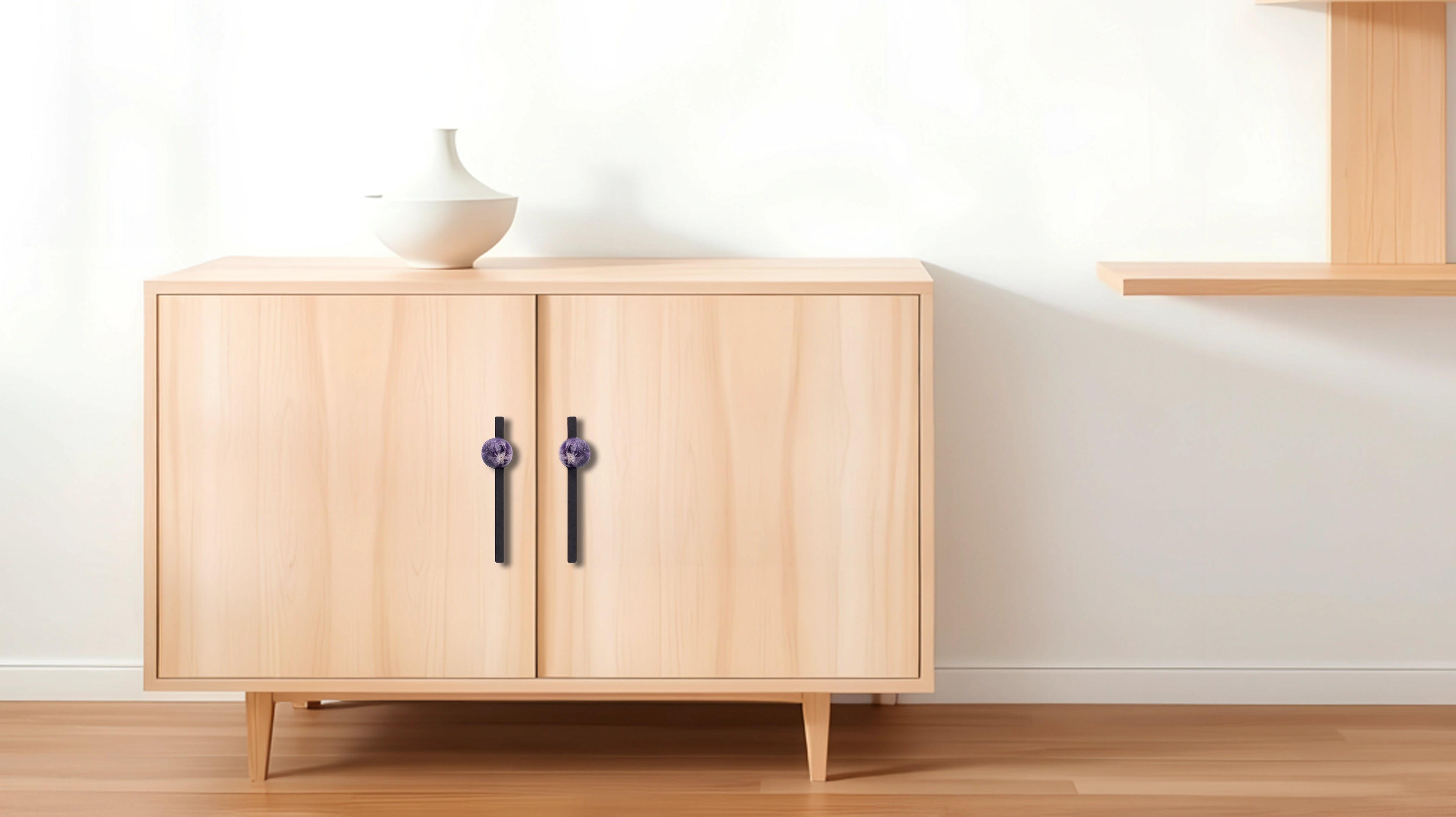 Wooden cabinet with two doors placed on a wooden floor against a white wall, offering a clean, natural look by Mantara.