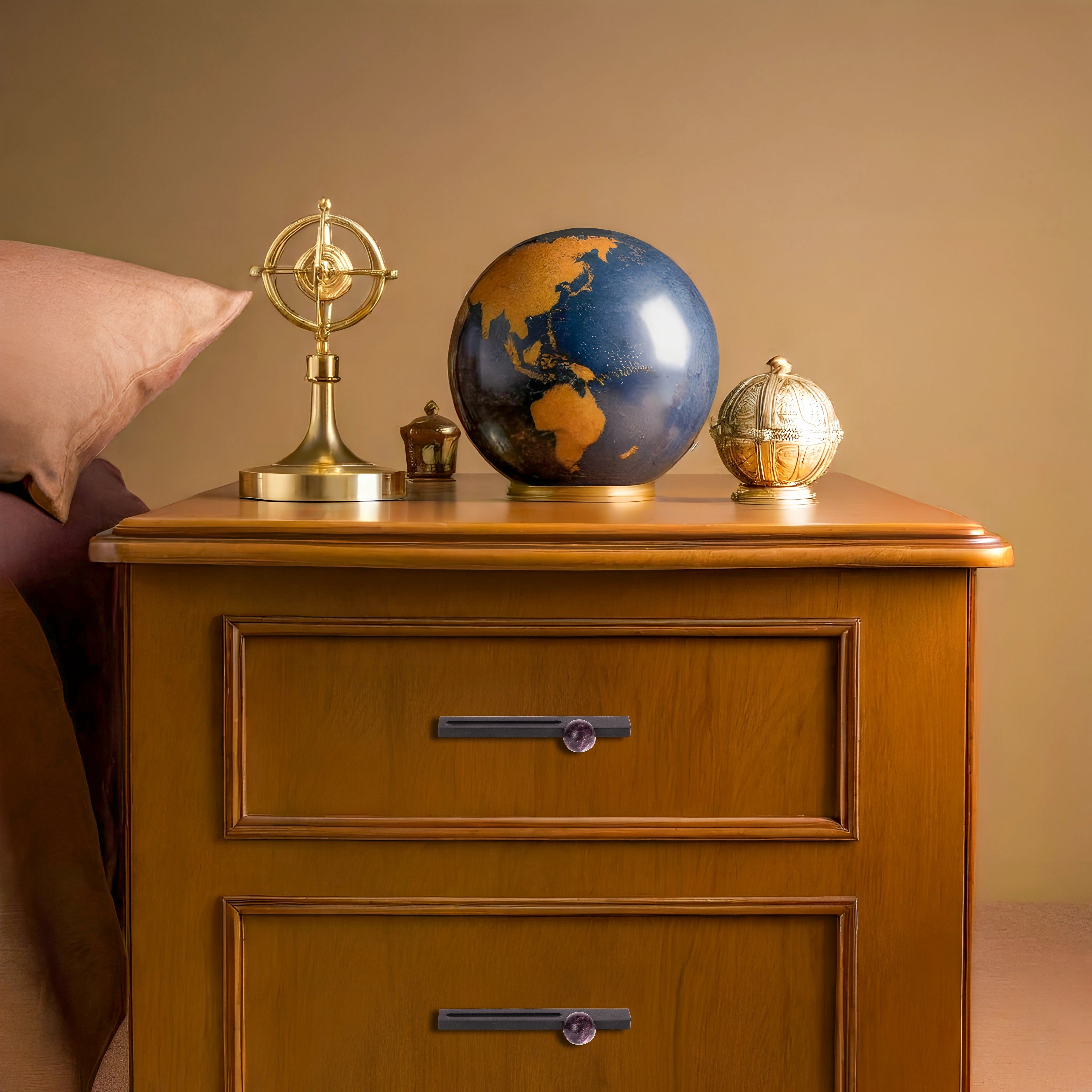 Wooden nightstand with decorative items including a globe and celestial-themed accents, styled elegantly by Mantara.