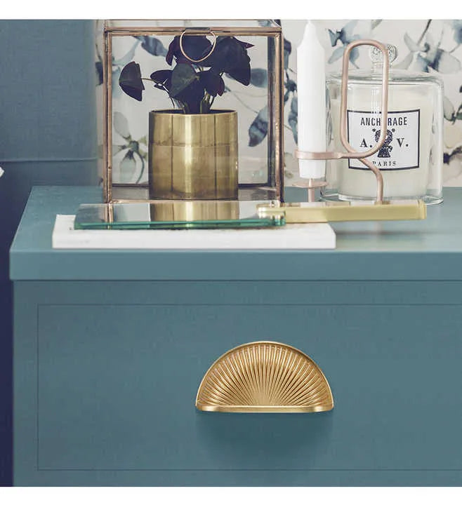The Odette Handle by Mantara B-0107 is a polished brass handle in gold, perfect for drawers, cupboards, and kitchens.