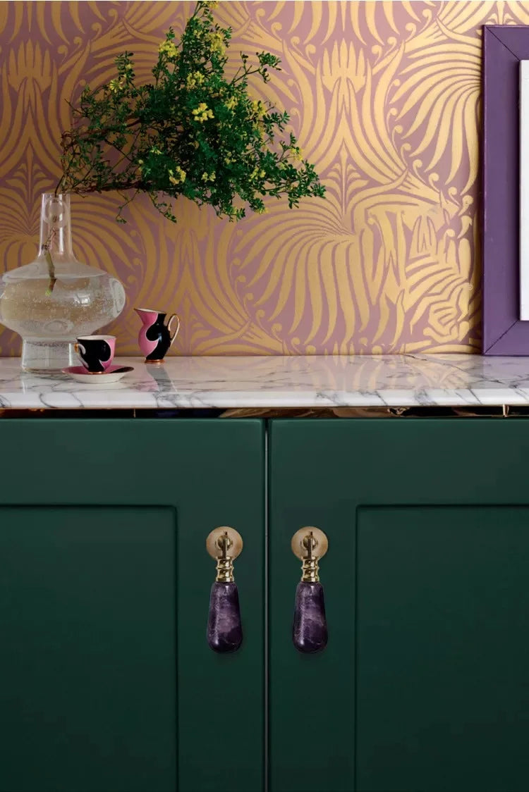 The Mantara C-0007 is a modern natural crystal + brass drop knob in purple, ideal for wardrobes and drawers.