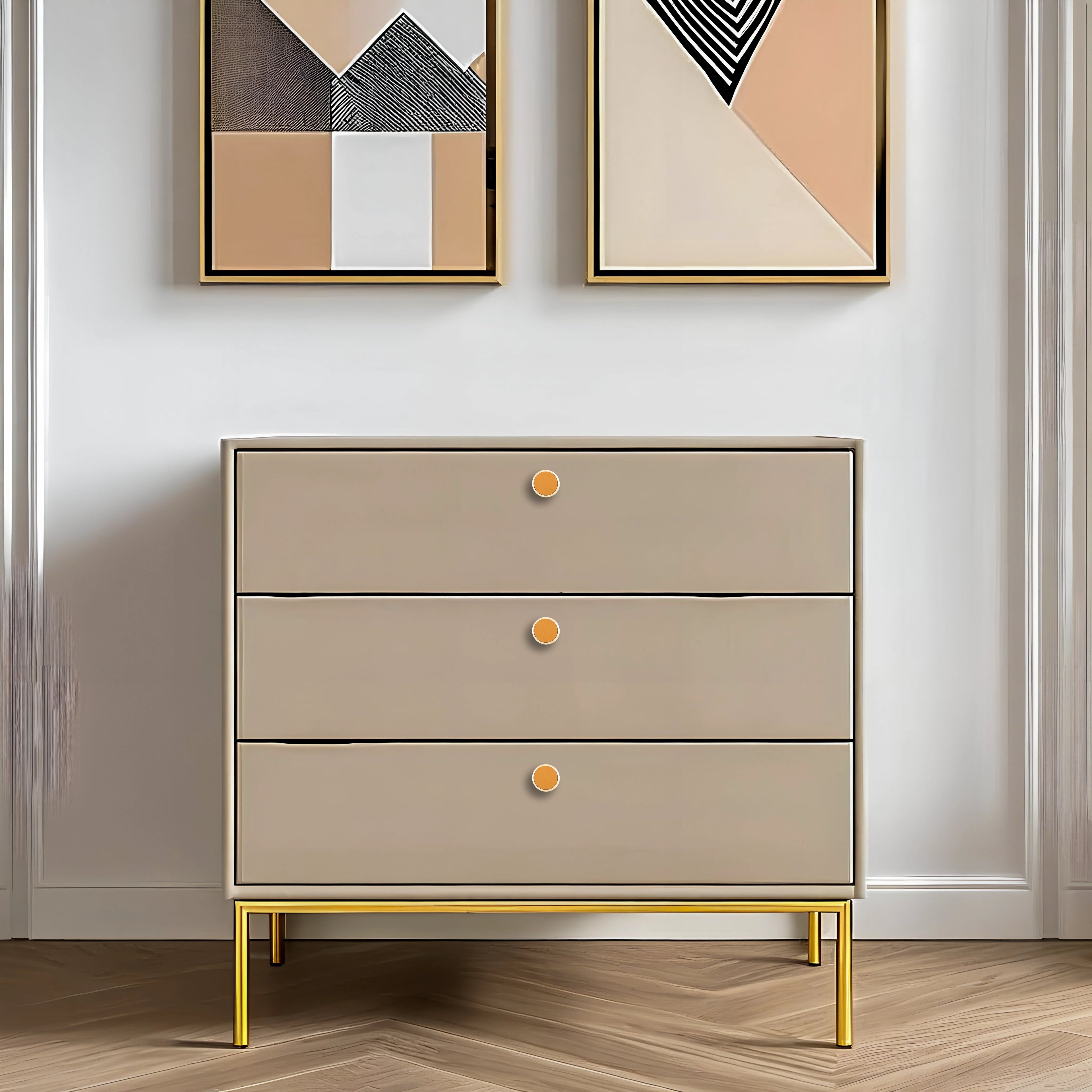 Beige dresser with gold legs and accents, placed against a white wall featuring abstract art, styled by Mantara.