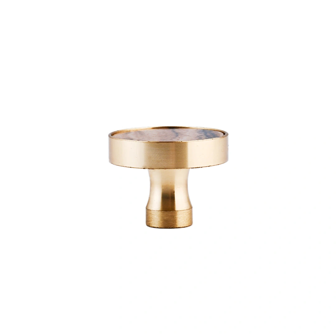 The Mantara M-0004 Carrara Knob is a modern stone and brass knob in Zebra stone, ideal for drawers and cabinets.