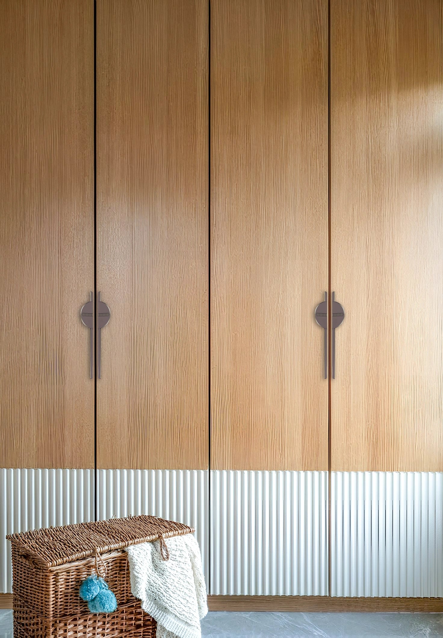 Wooden wardrobe with zinc handles, set against a white paneled wall—blending warmth and modern contrast by Mantara.