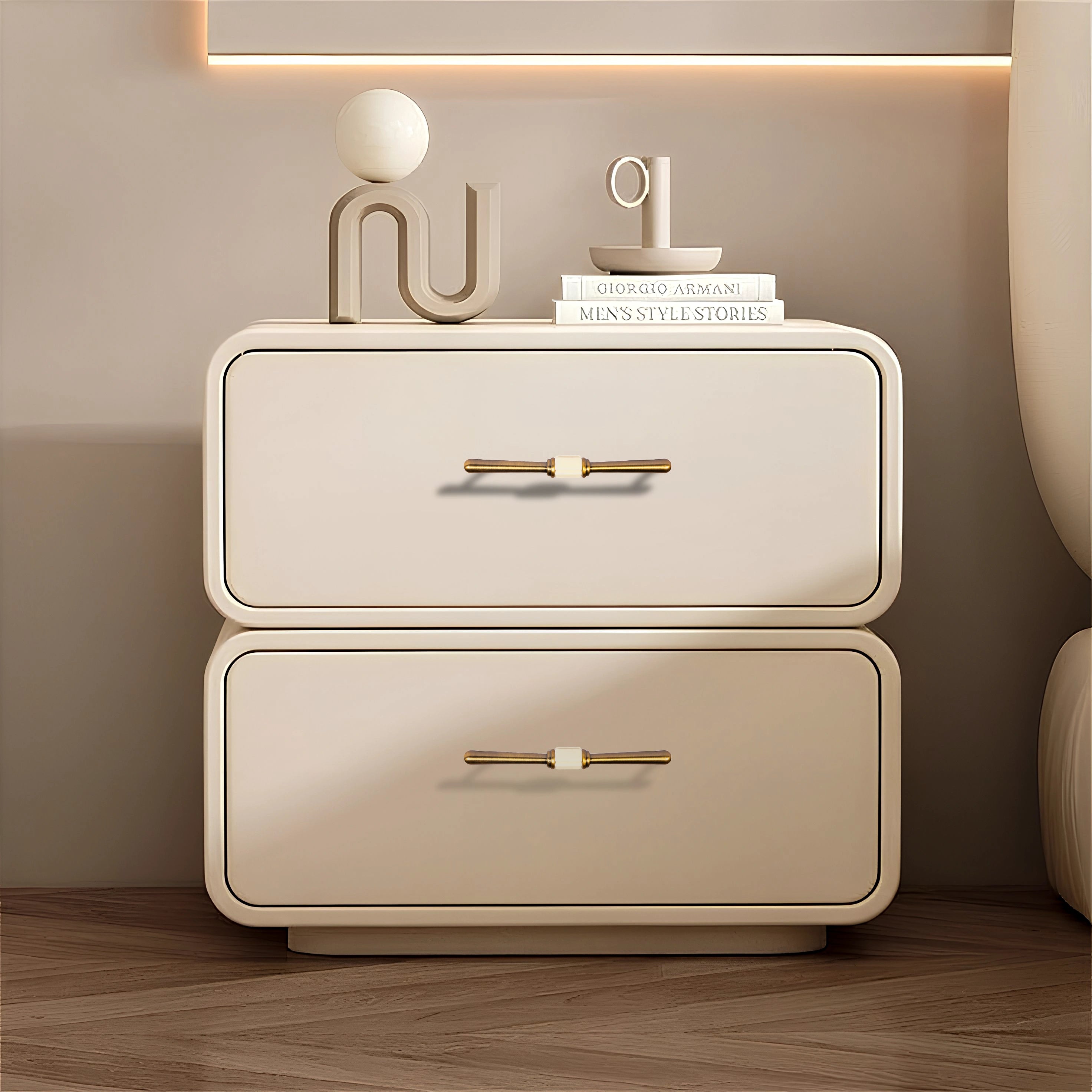 Beige nightstand with two drawers and Bronze handles, styled with decorative items on a wooden floor—by Mantara.