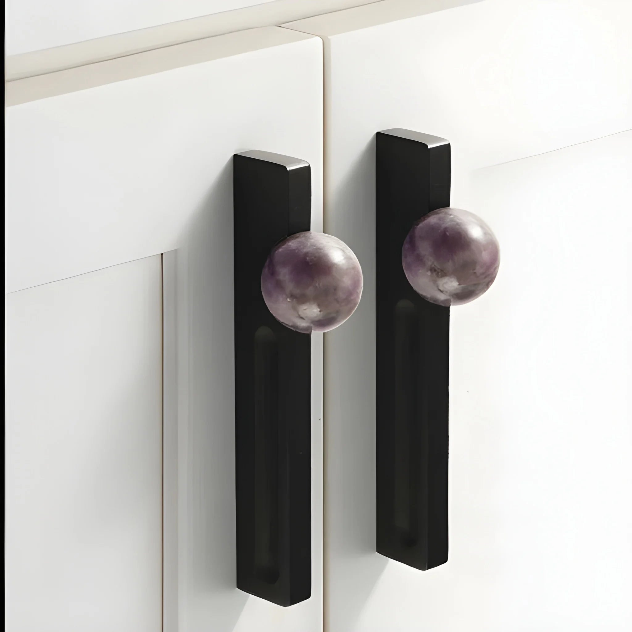 The Mantara C-0027 Calyx Handle is a modern crystal handle in black+purple, ideal for cabinets, wardrobes, and drawers.