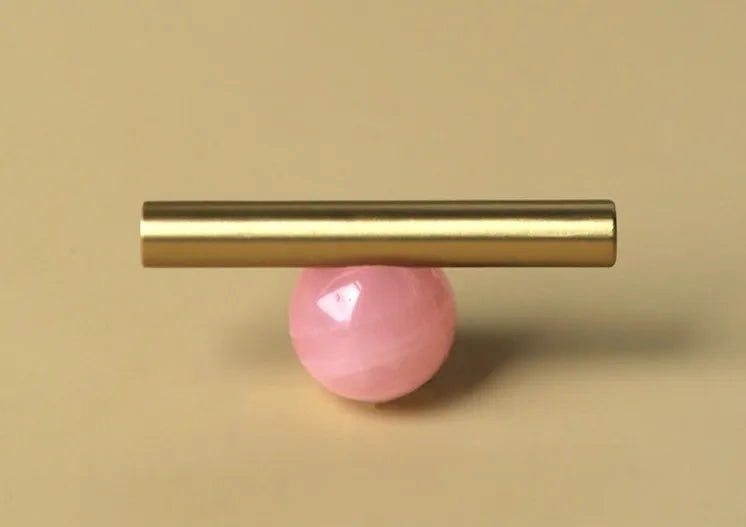 The Mantara C-0020 Chroma T-Bar is a modern crystal and brass knob in pink, ideal for drawers and cabinets.