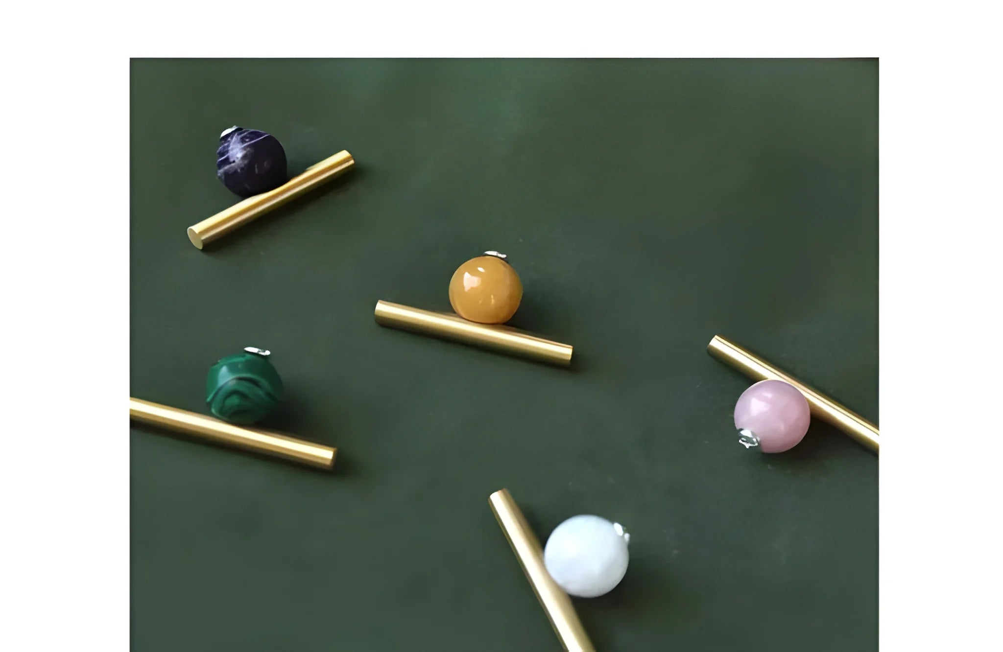 The Mantara C-0020 Chroma T-Bar is a modern crystal and brass knob in pink, purple, green, and white, ideal for drawers and cabinets.