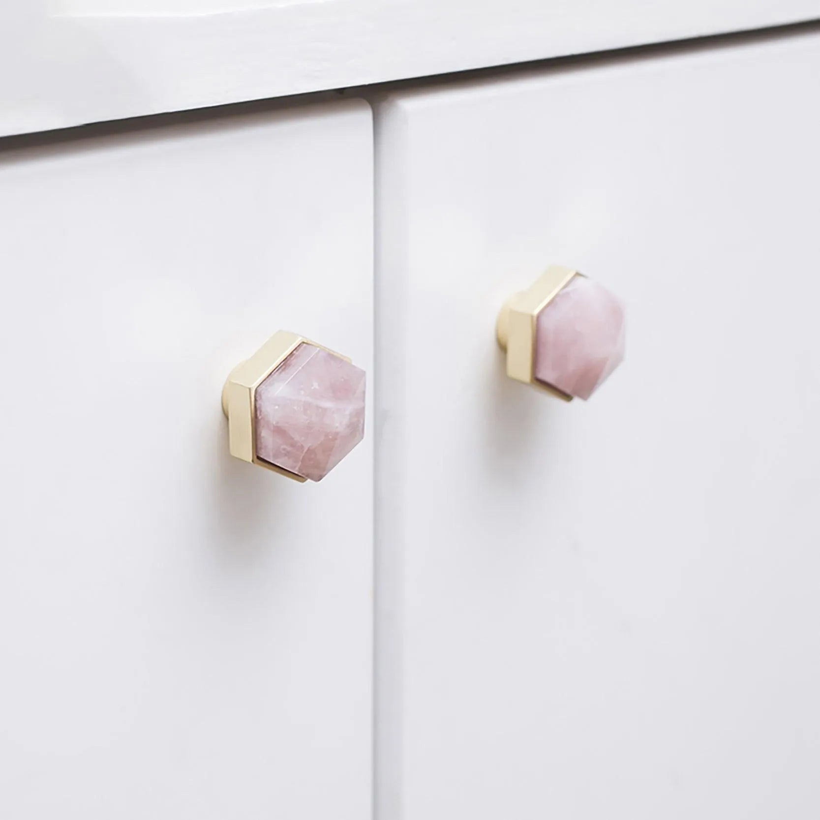 The Mantara C-0005 is a modern crystal + brass knob in pink, ideal for cabinets and wardrobes.