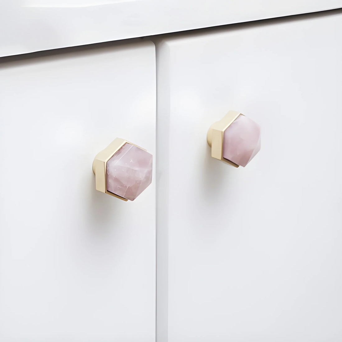The Mantara C-0005 is a modern crystal + brass knob in pink, ideal for cabinets and wardrobes.