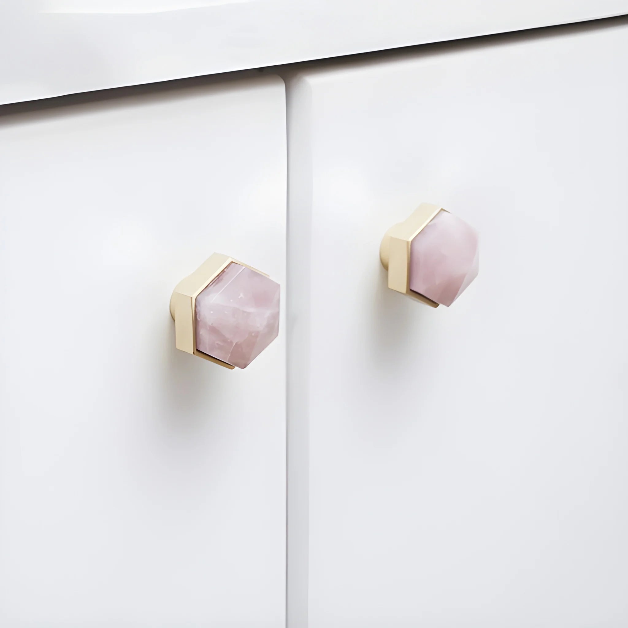 The Mantara C-0005 is a modern crystal + brass knob in pink, ideal for cabinets and wardrobes.
