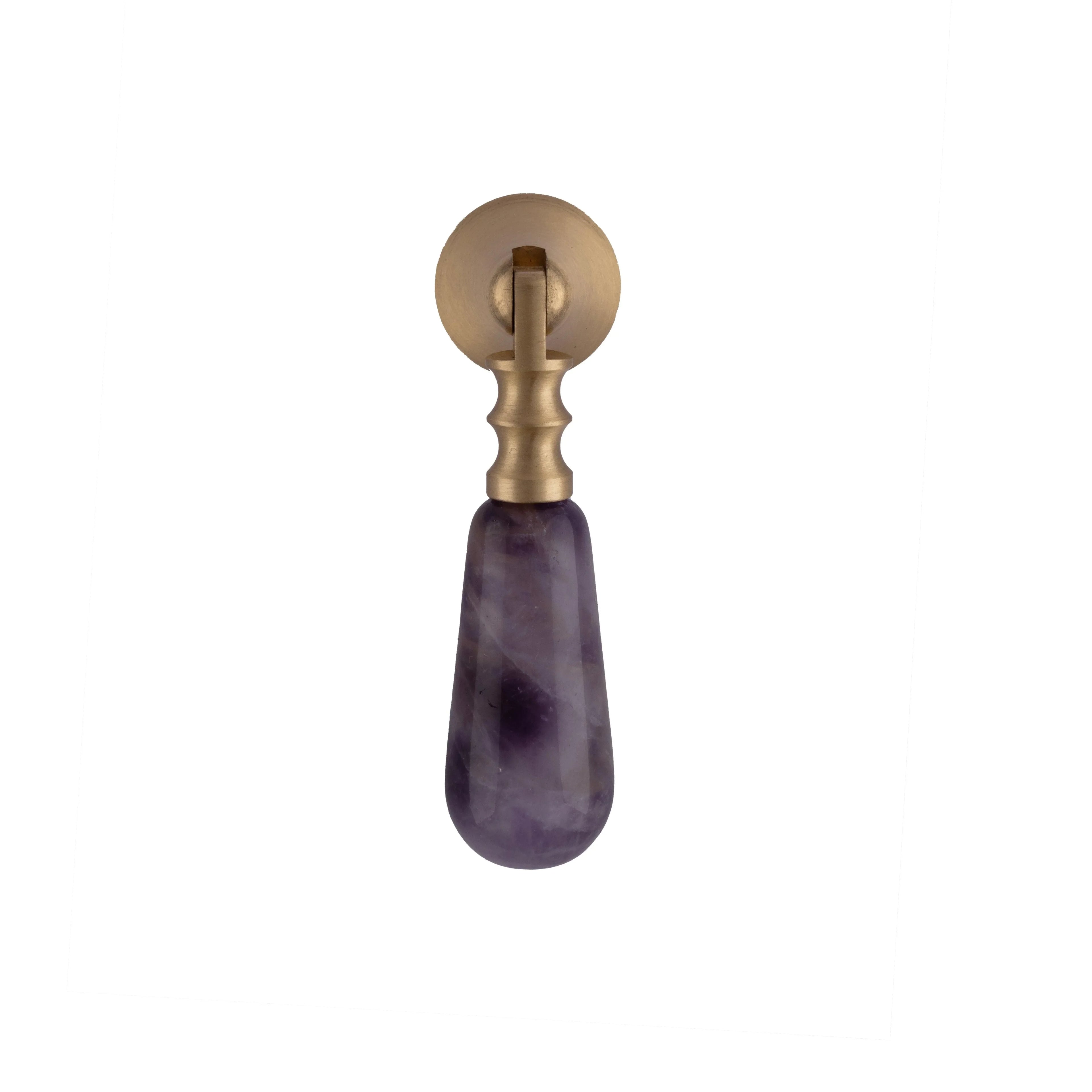 The Mantara C-0007 is a modern natural crystal + brass drop knob in purple, ideal for wardrobes and drawers.