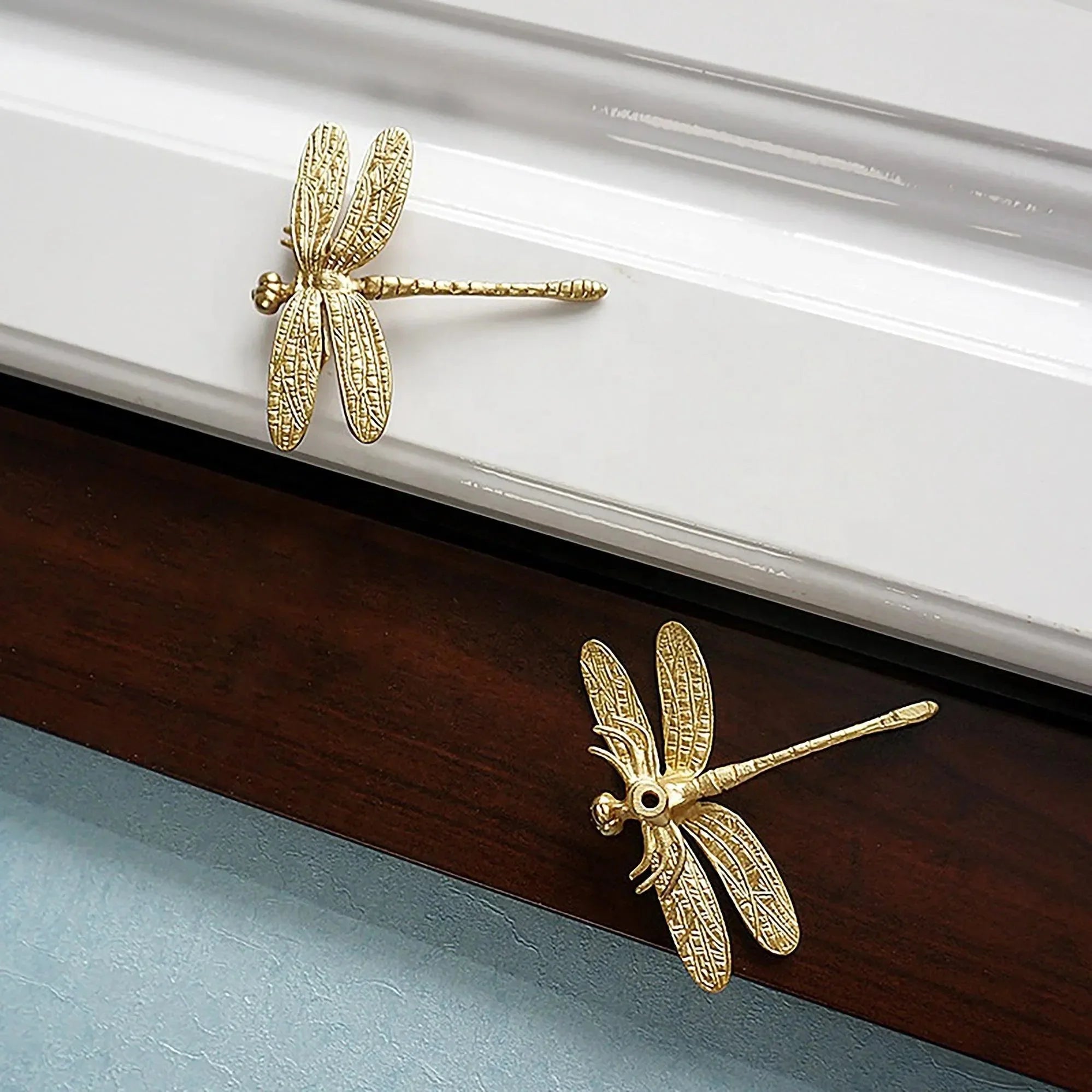 The Mantara B-0015 Dragonfly Knob is a modern solid brass knob in polished gold, perfect for wardrobes, cabinets, and drawers.