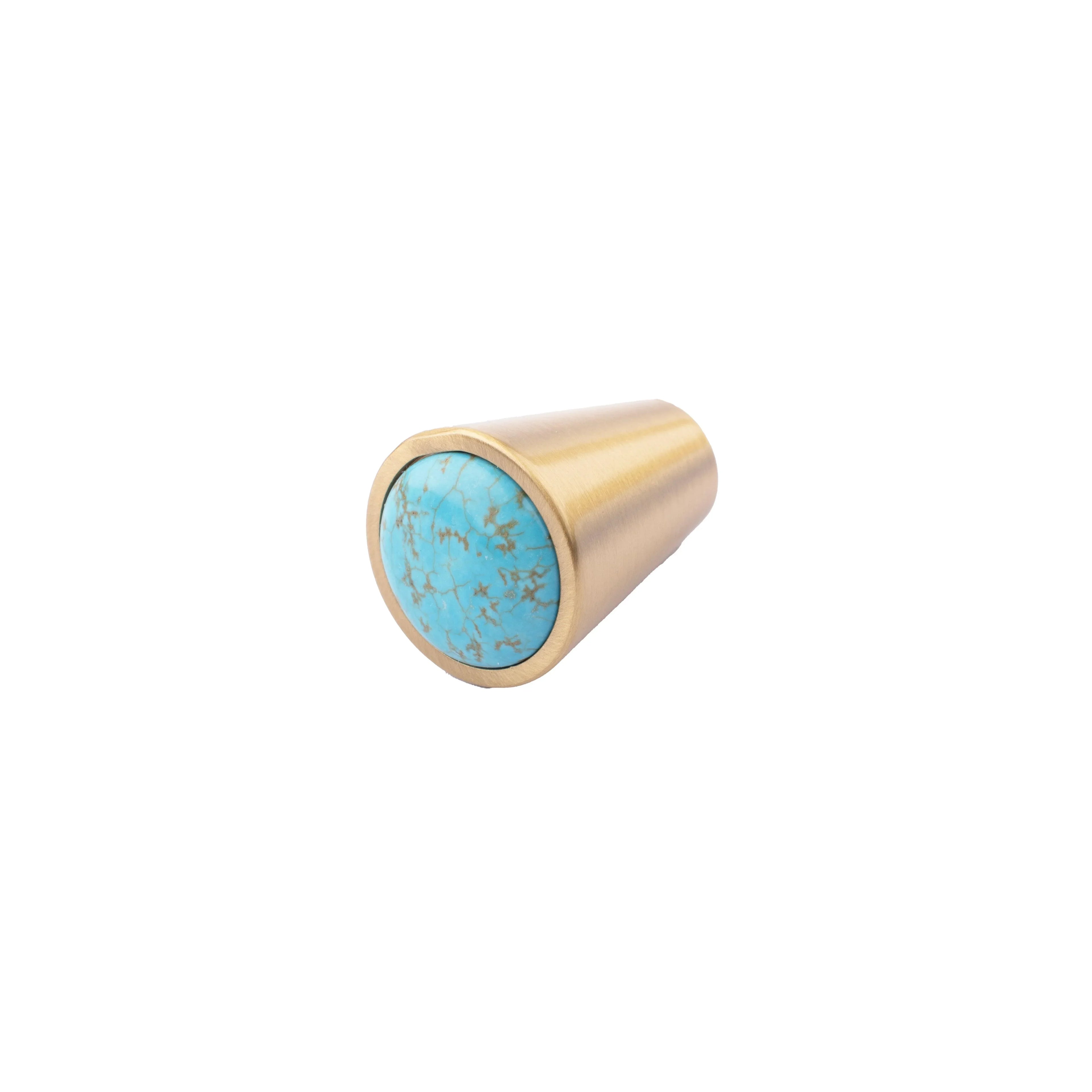 Gold cylindrical object with turquoise stone on a white background
