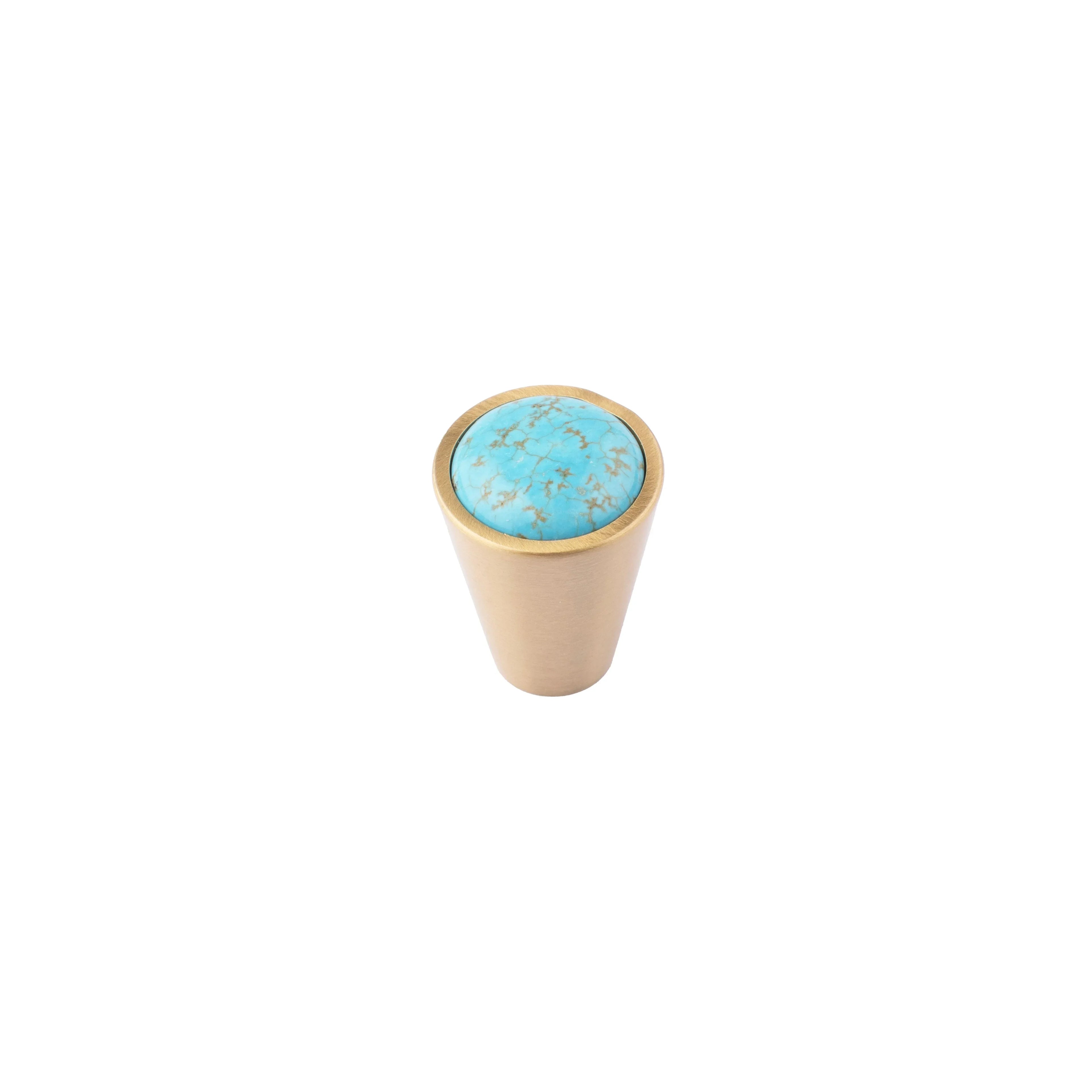 Small cylindrical object with turquoise top and beige bottom on a white background