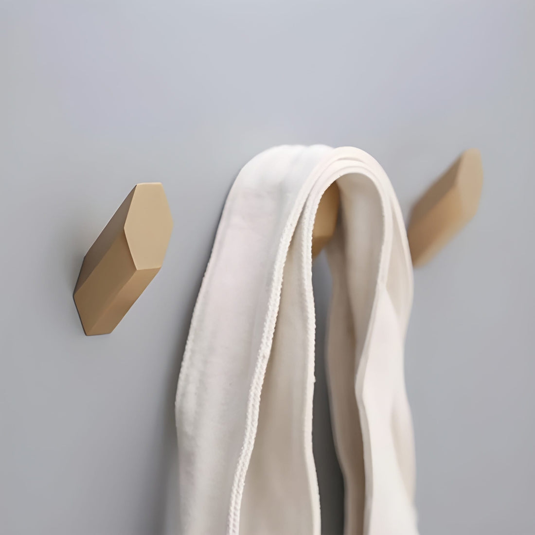 Mantara Hexa Hook B-0091 is a modern brushed brass wall hook in gold, perfect for bathrooms, bedrooms, and living areas.