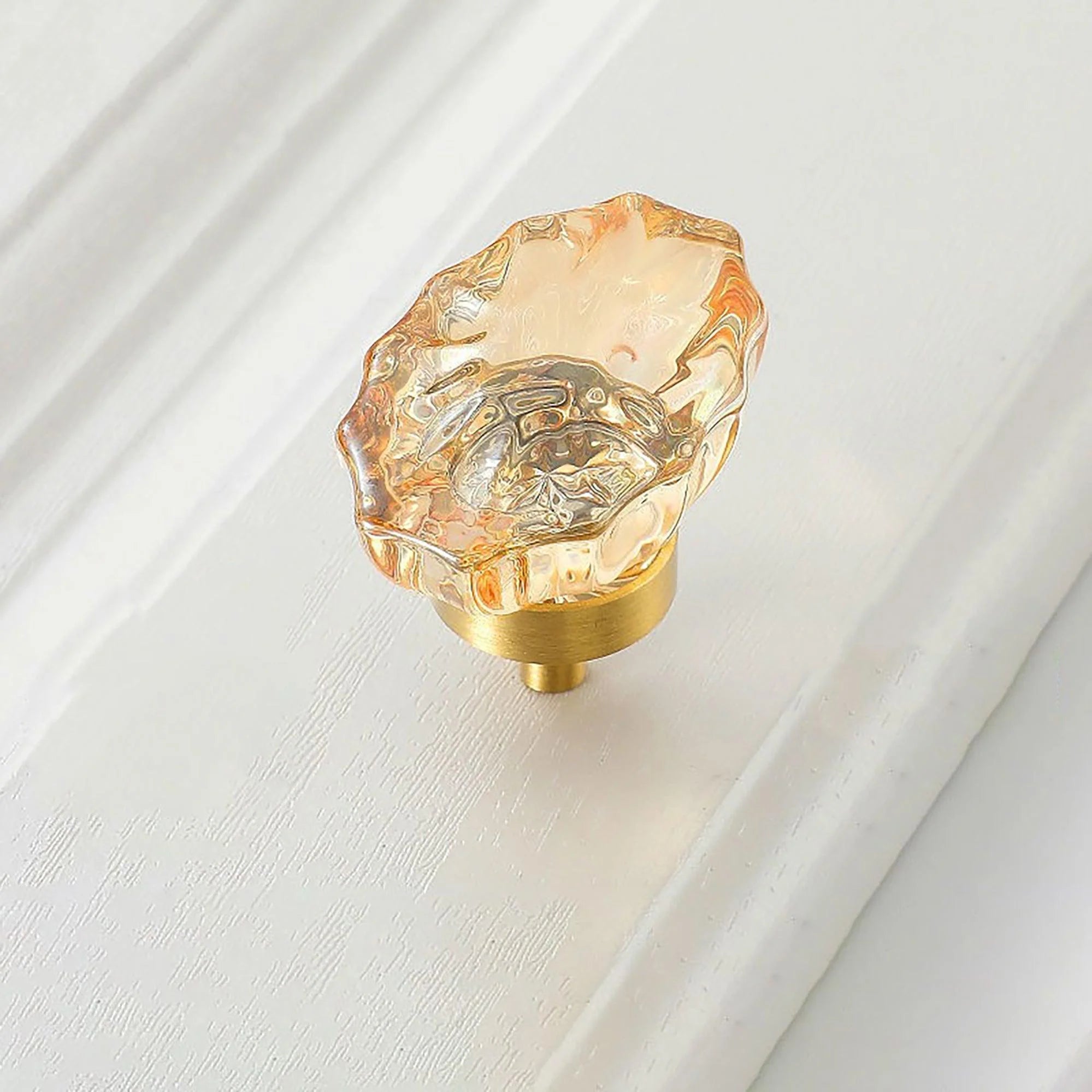 The Mantara C-0009 is a modern artificial crystal + brass knob in champange/brass, ideal for kitchens and cabinets.