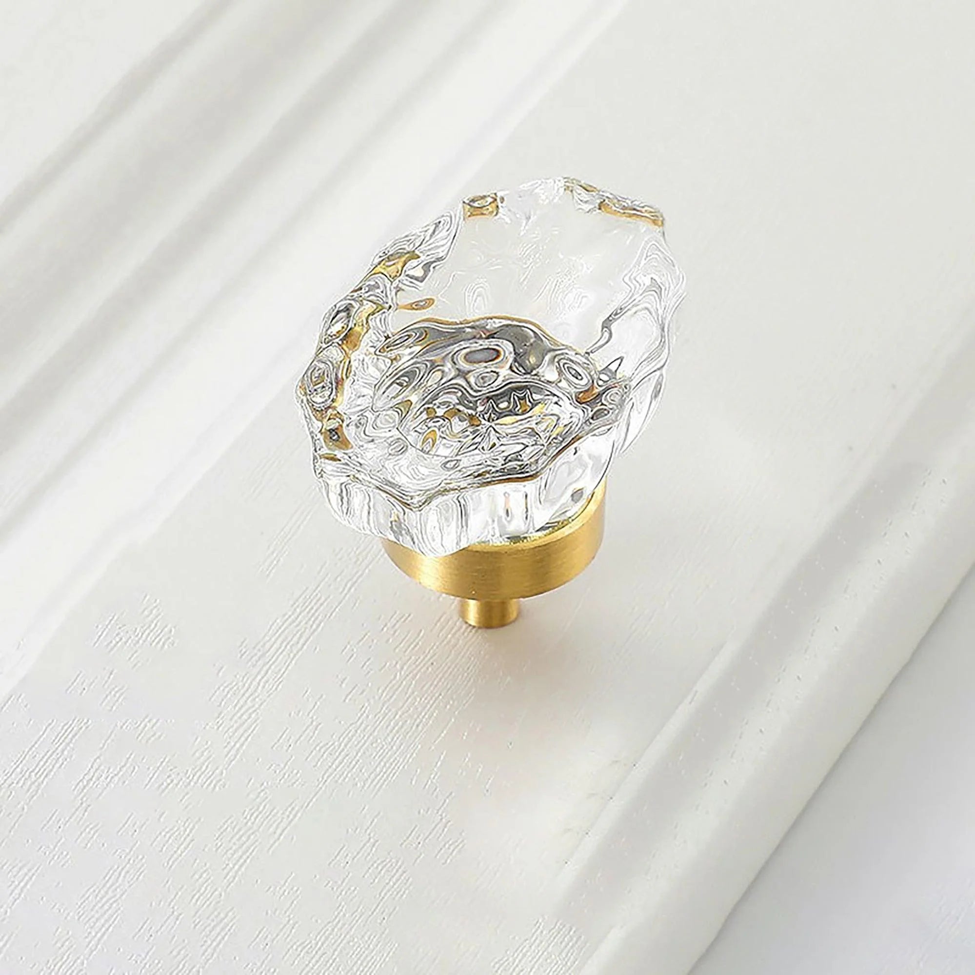The Mantara C-0009 is a modern artificial crystal + brass knob in white/brass, ideal for kitchens and cabinets.