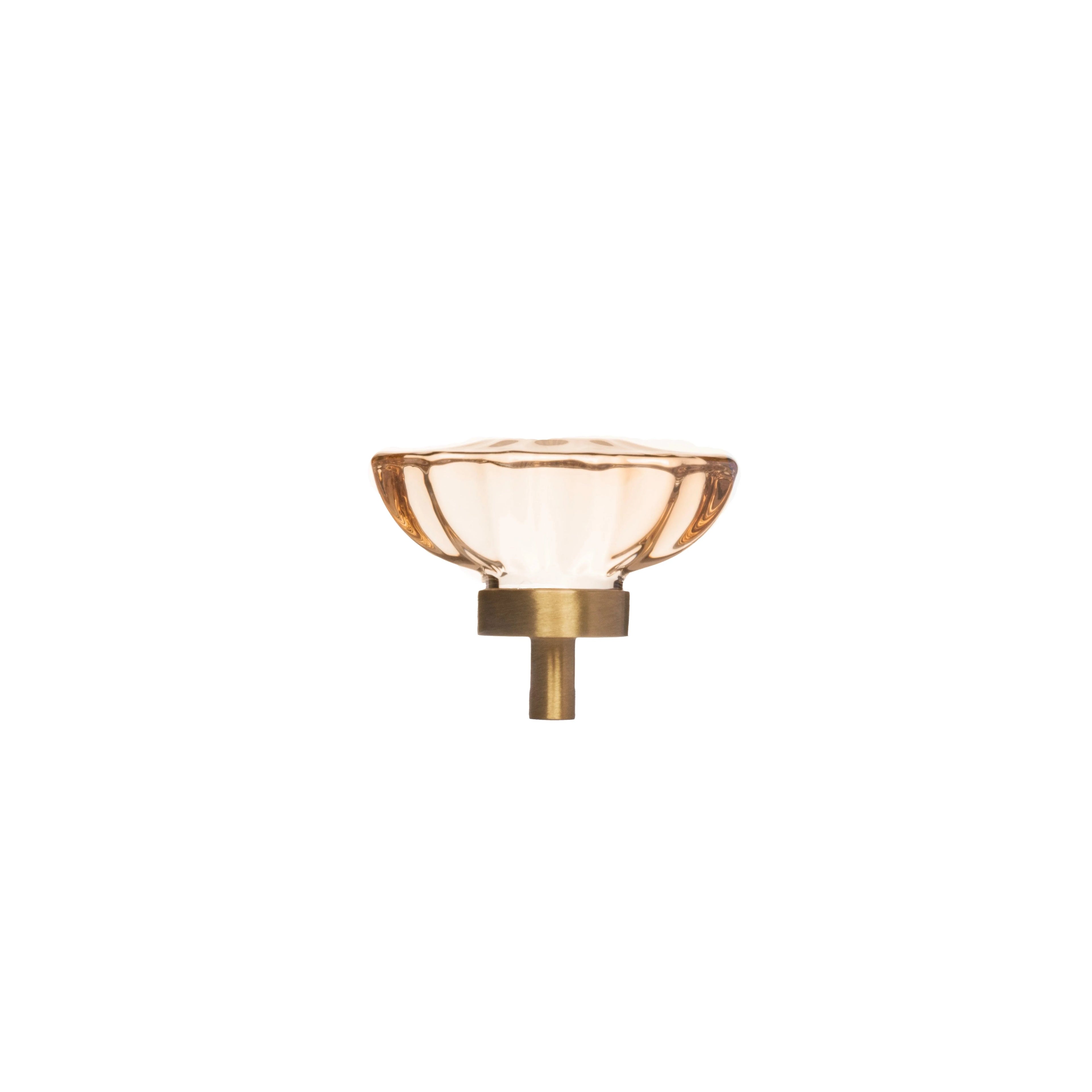 The Mantara C-0009 is a modern artificial crystal + brass knob in champange/brass, ideal for kitchens and cabinets.
