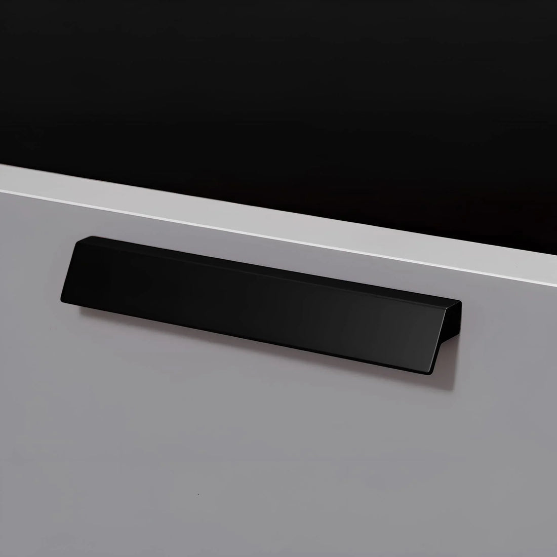 The Mantara AL-0015 Tara Handle is a modern black aluminum handle with a brushed finish, ideal for kitchens, drawers, and cabinets.