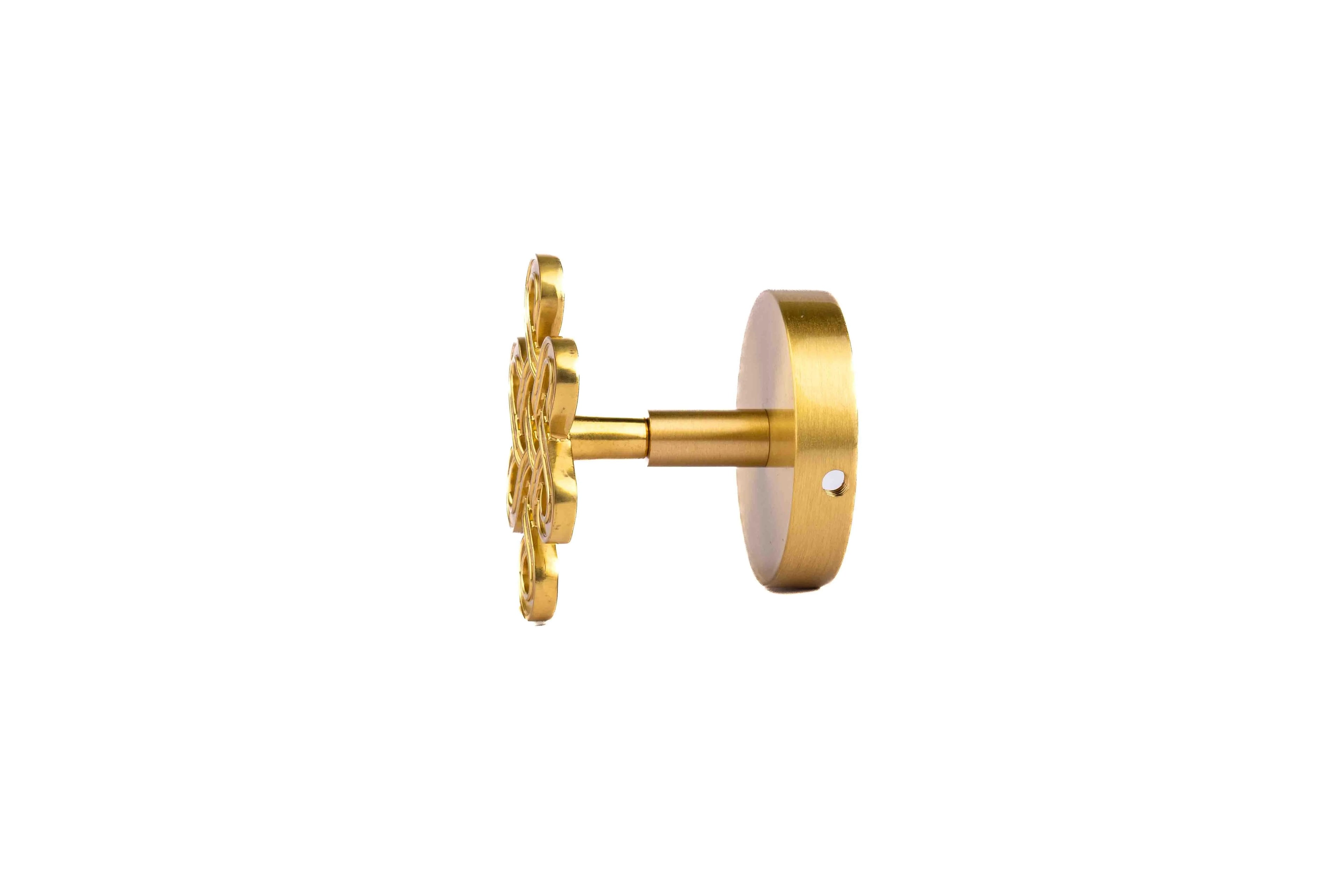 The Lattice Hook by Mantara B-0116 is a modern brass wall hook in gold with a brushed finish, ideal for kitchens and bedrooms.