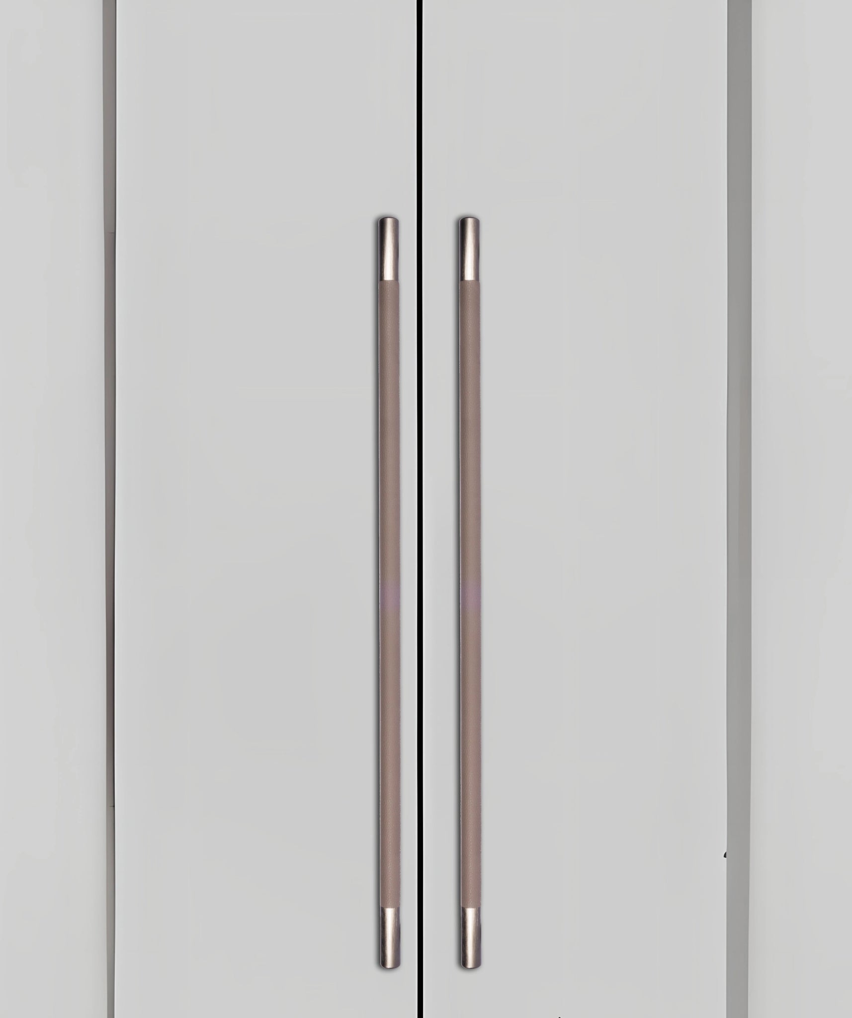 Gray cabinet doors with sleek metallic handles, blending seamlessly into a gray background, styled by Mantara.