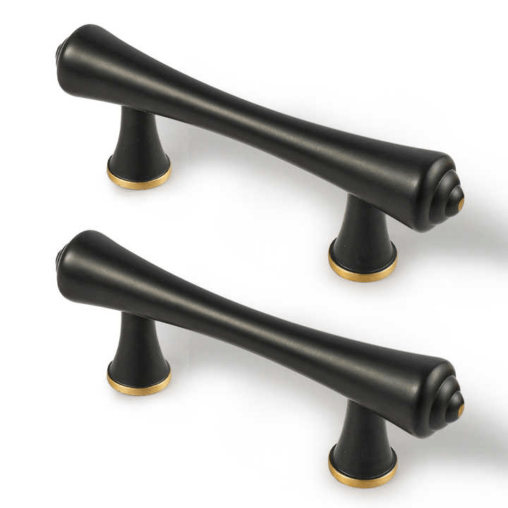 Two black cabinet handles with gold accents, displayed on a clean white background—elegant contrast by Mantara.