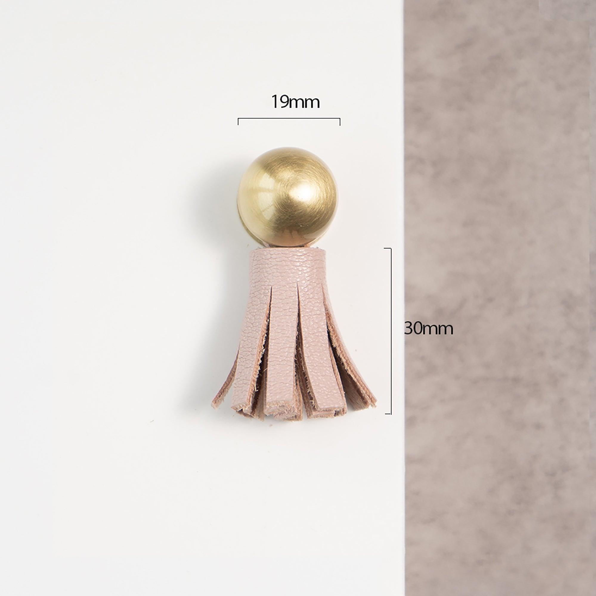 The Mantara L-0002 Maverick Drop Knob is a modern leather and brass knob in pink, ideal for kitchens and furniture.