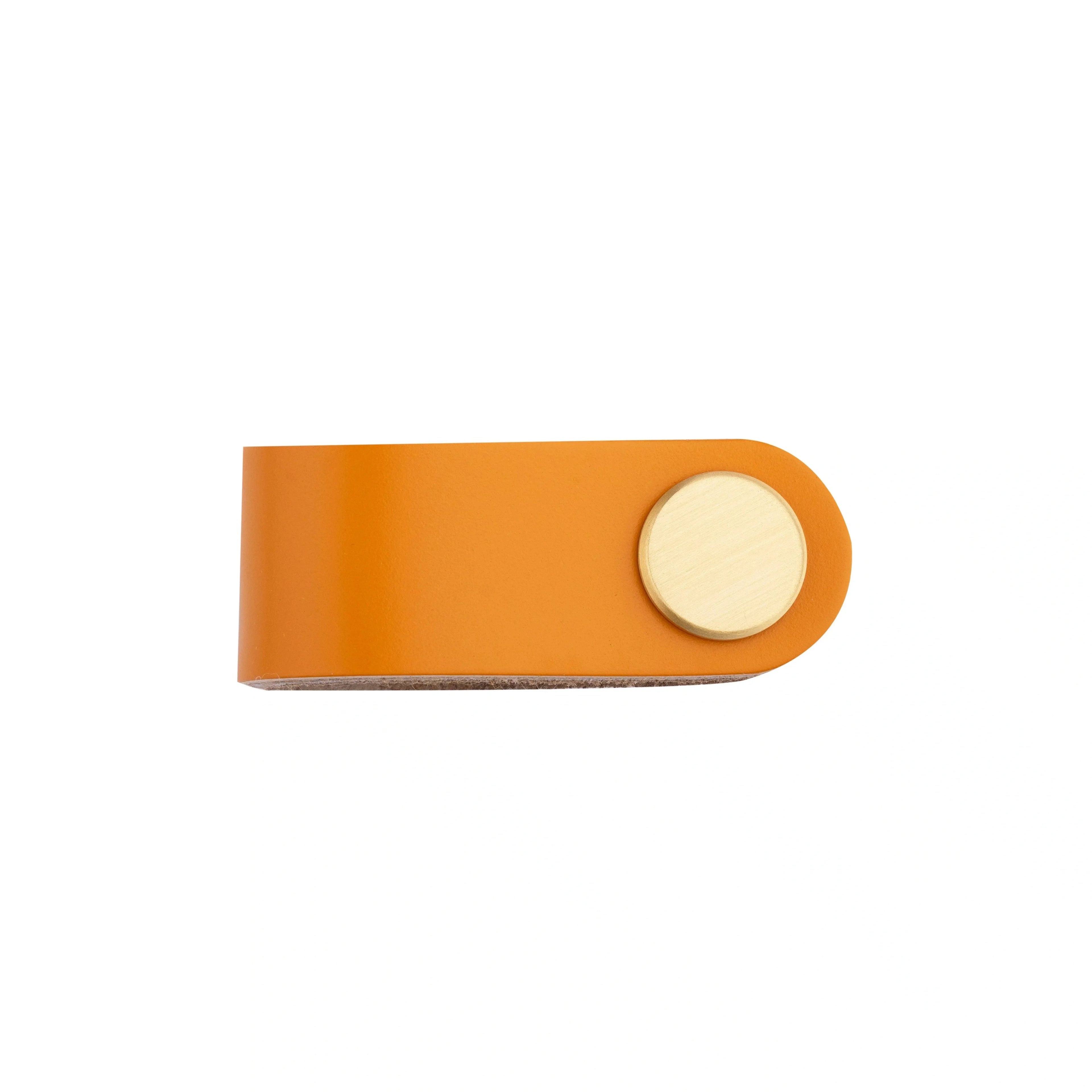 The Mantara L-0001 Maverick Pull Knob is a Nordic leather and brass knob in orange, ideal for kitchens and furniture.