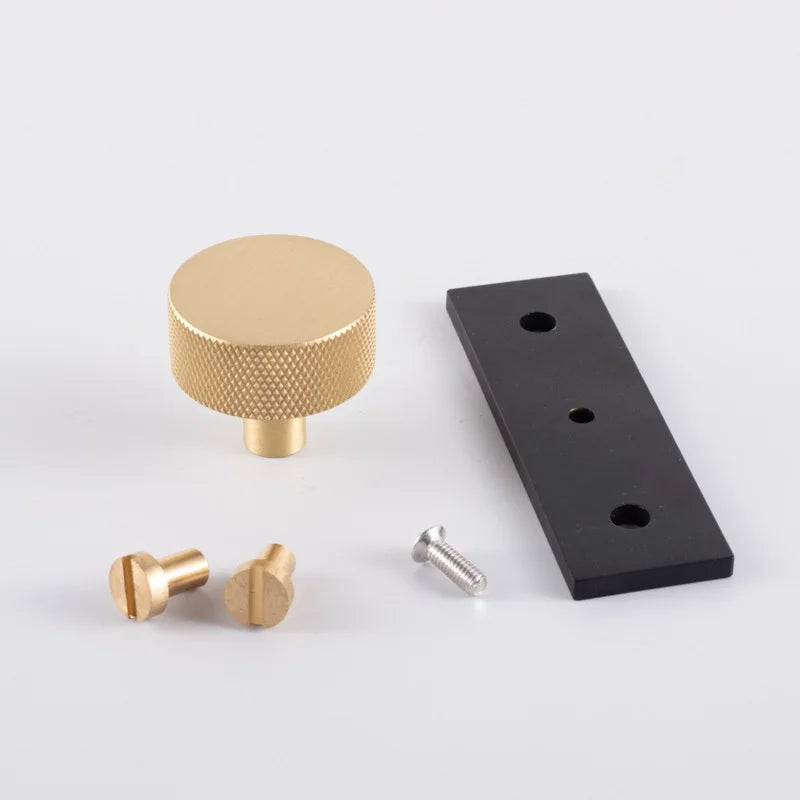 The Mantara B-0118 is a modern brass knob in gold with a black stabiliser base, ideal for kitchen and dresser drawers.