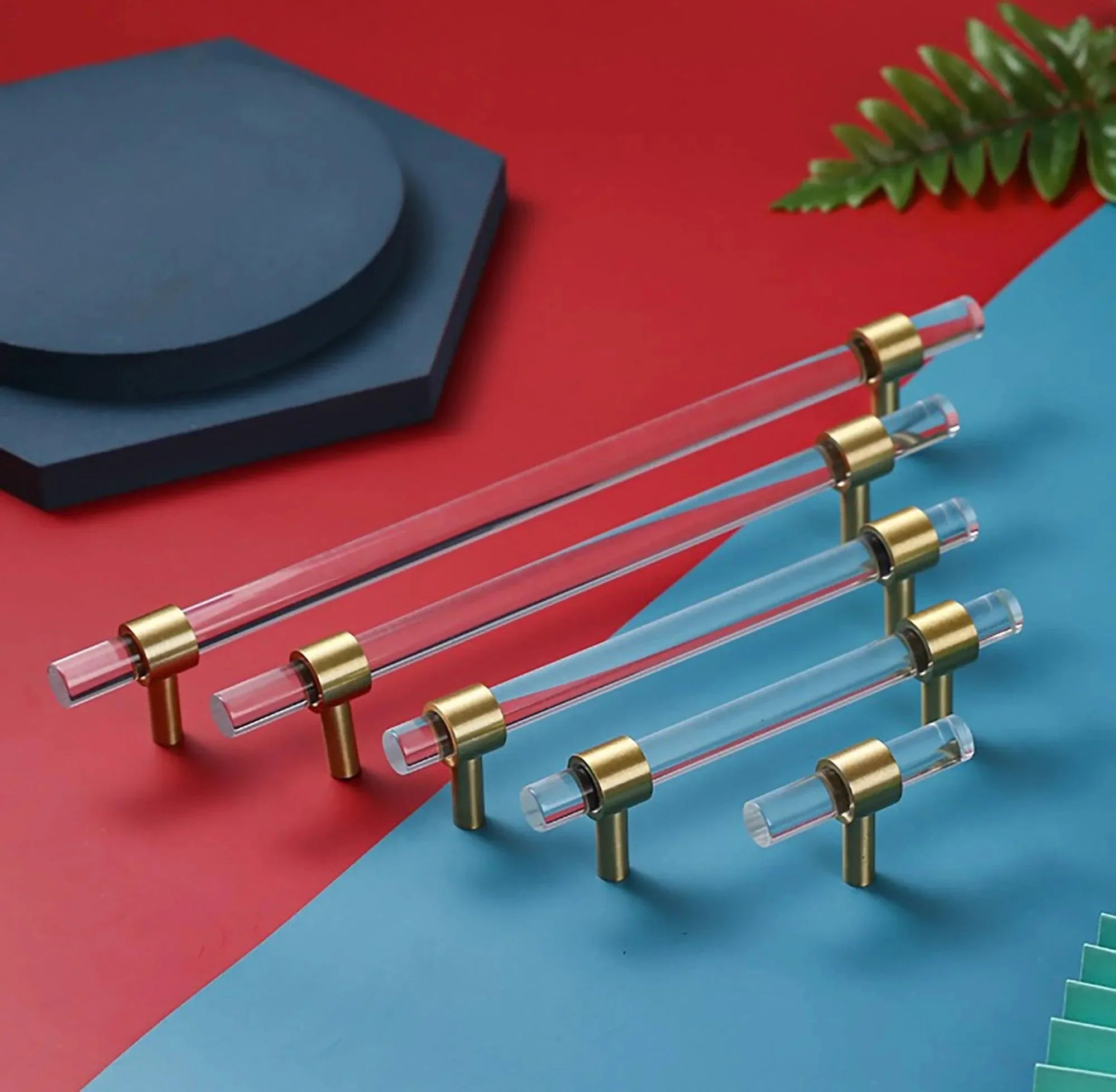 A sleek T-bar handle, Petra II made of clear acrylic with brushed brass supports in transparent white finish, model A-0008 by Mantara, A-0008.
