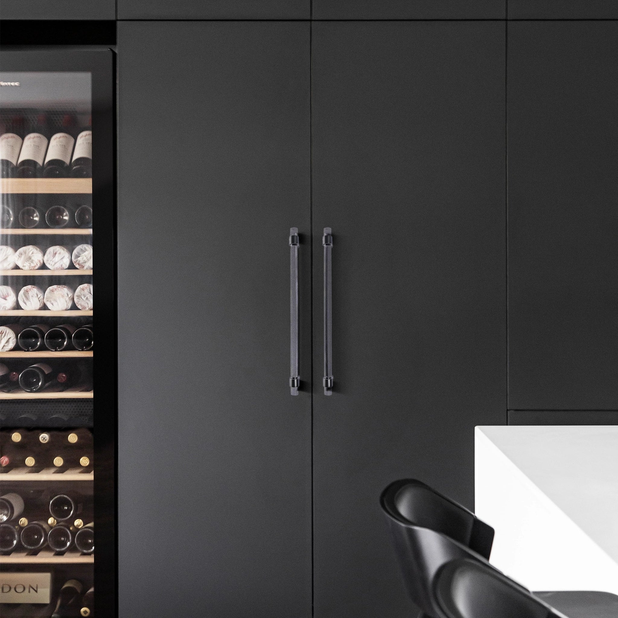 An elegant cabinet bar handle, Petra IV crafted from acrylic in polished black finish, model A-0010 by Mantara, A-0010.