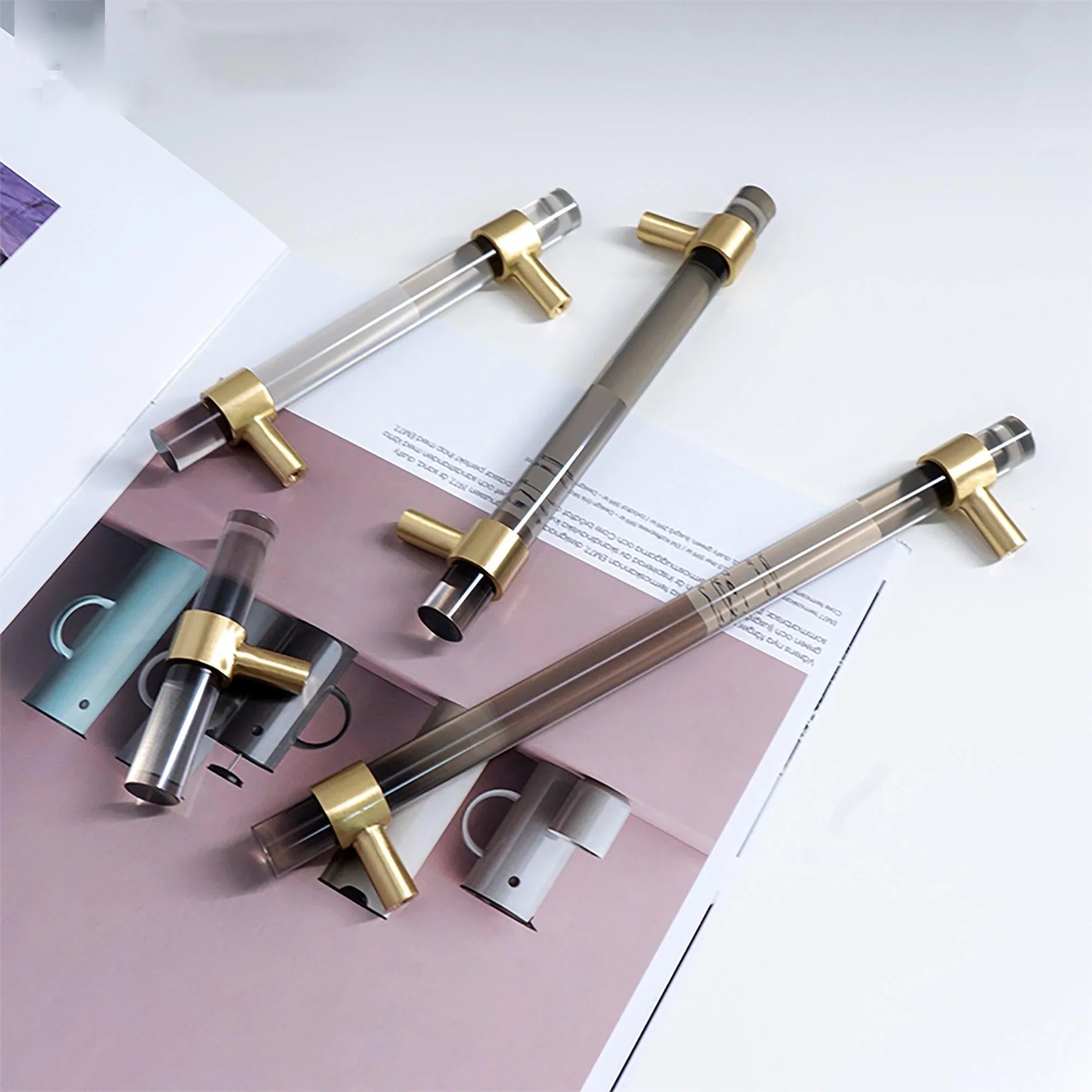 A modern cabinet bar handle, Petra V crafted from grey acrylic with polished brass mounts, model A-0011 by Mantara, SKU A-0011.