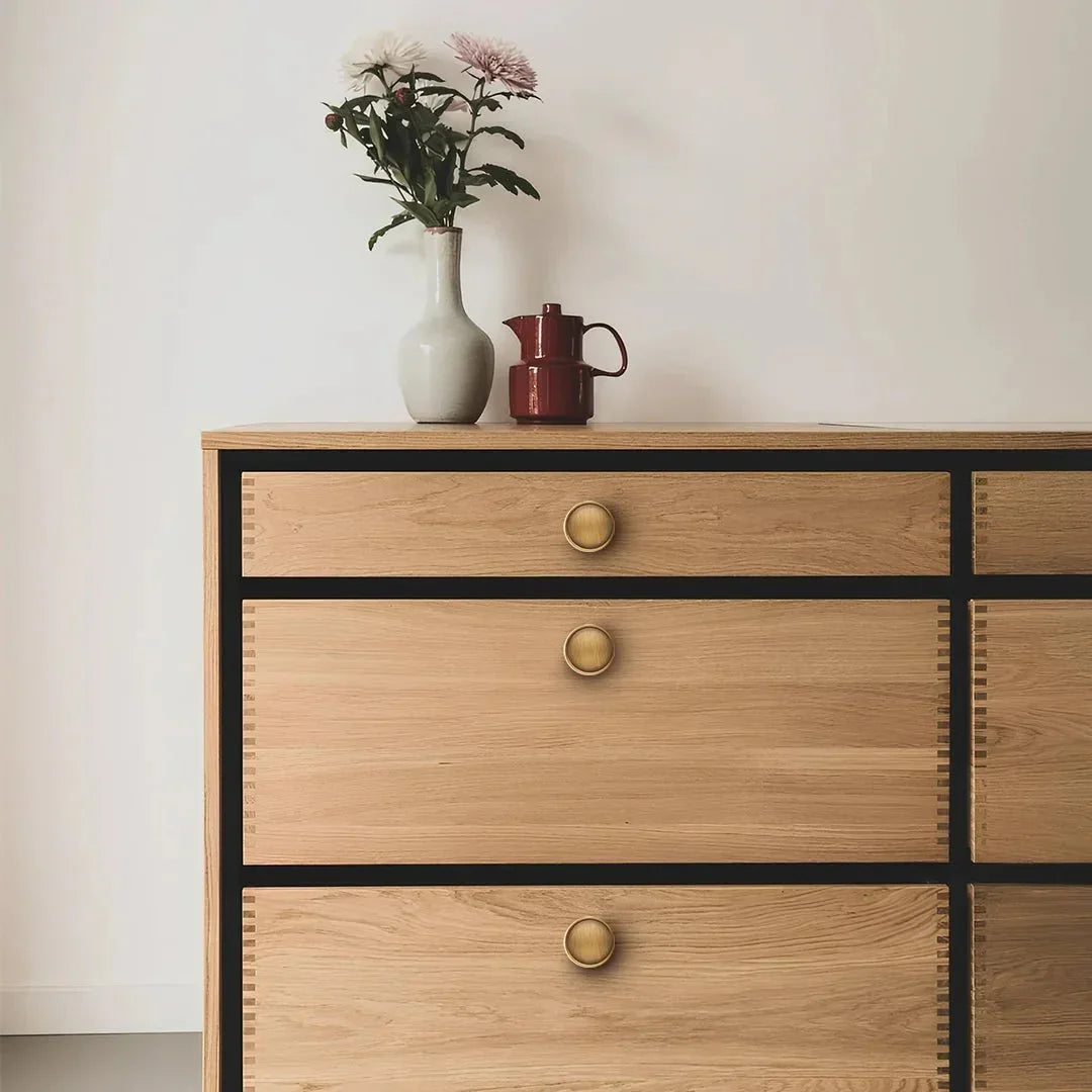The Mantara B-0007 Regina Knob is a modern brass knob in satin gold and bronze, perfect for kitchens, cabinets, and furniture.