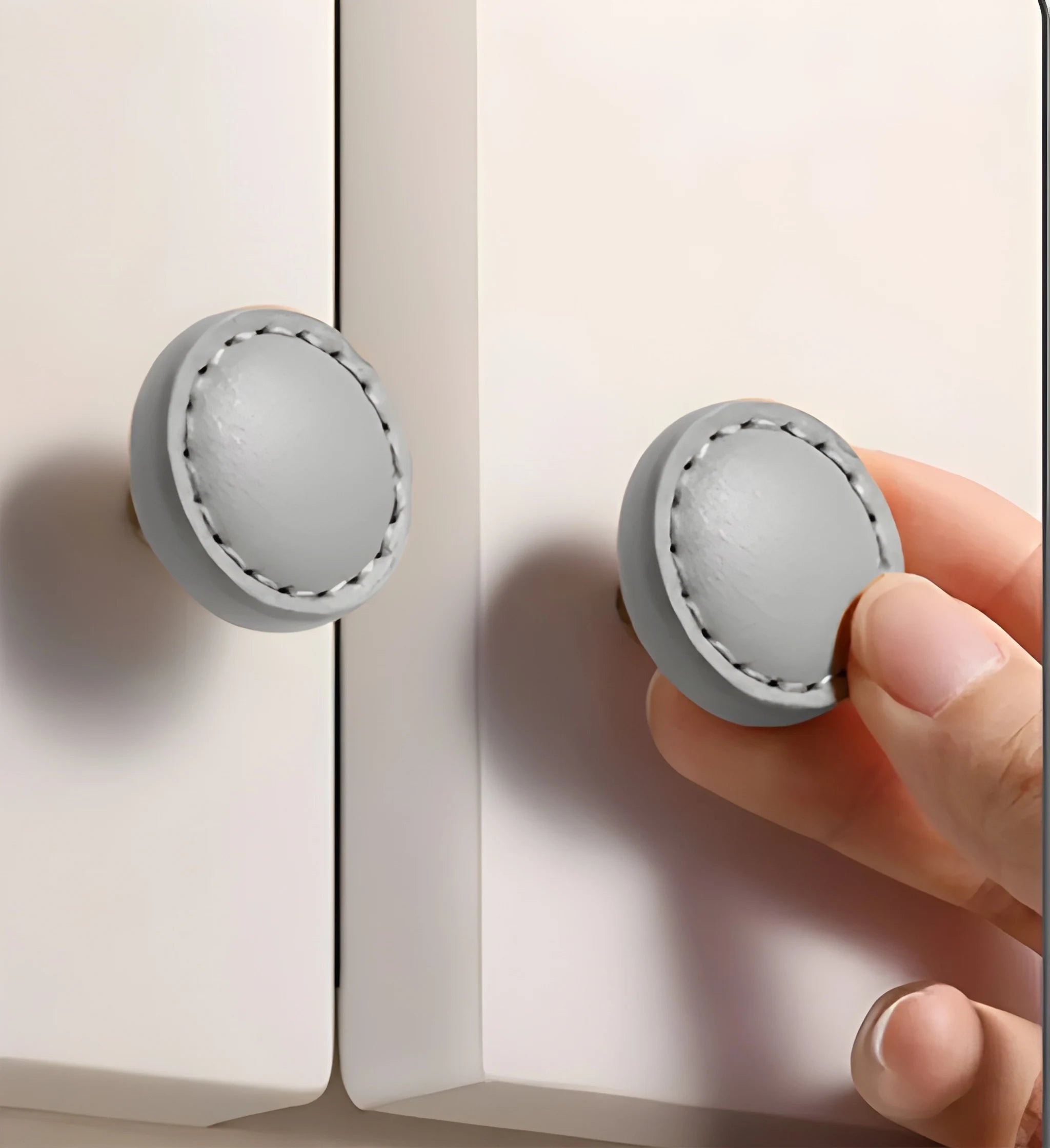 The Mantara L-0008 Sofia Round Knob is a modern leather knob in grey, ideal for cabinets and wardrobes.