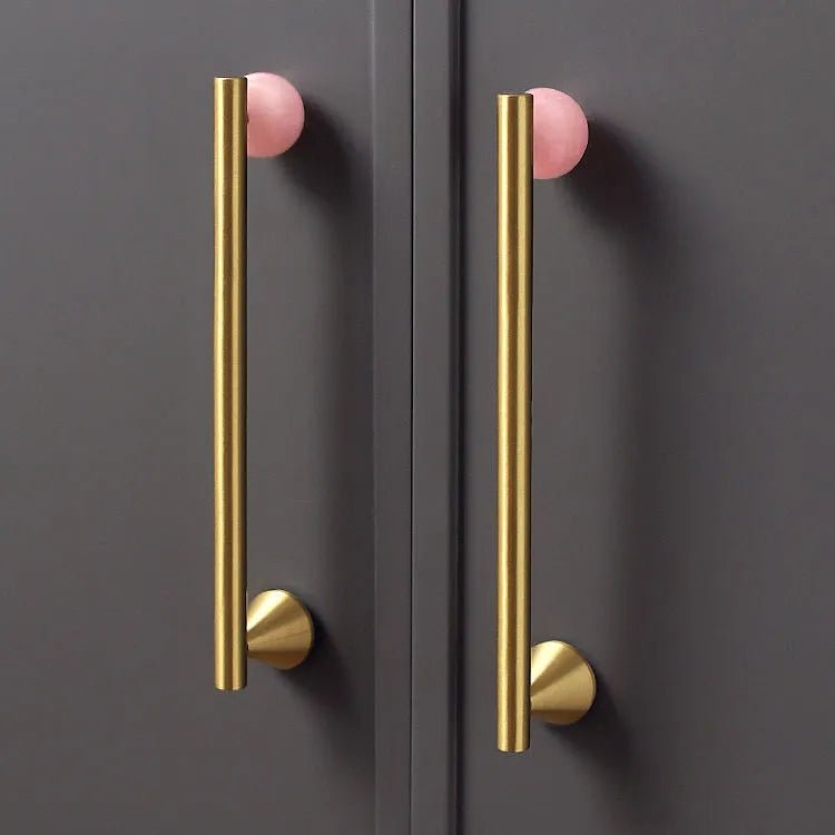 The Mantara C-0022 Solstice Handle is a modern crystal and brass handle in pink, ideal for wardrobes, drawers, and cabinets.