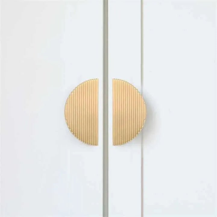 The Sorelle Handle by Mantara B-0113 is a modern brushed brass knob in gold, perfect for kitchen drawers and cabinets.