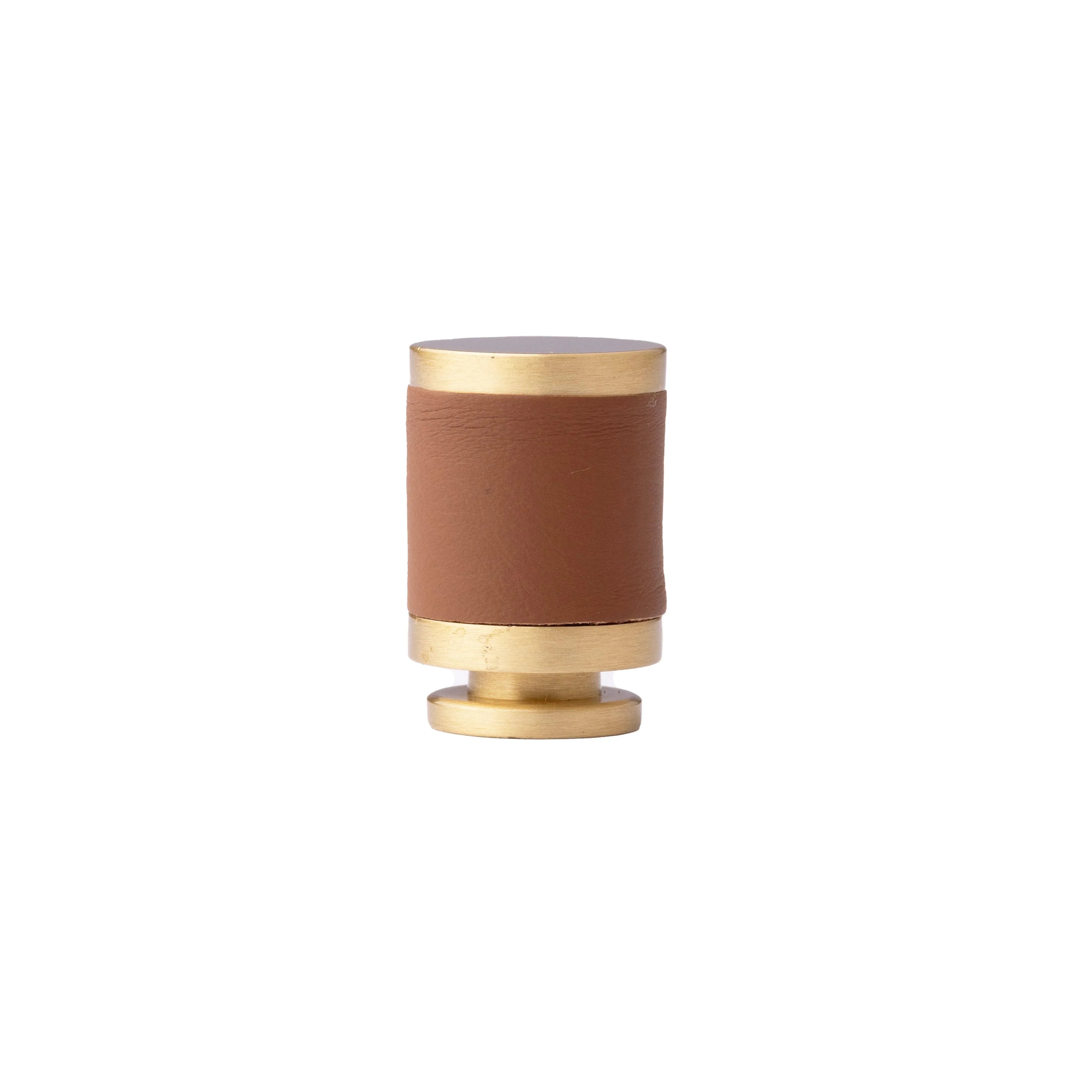 The Mantara L-0003 Tanner Knob is a modern brass and leather knob in brown, perfect for cabinets and furniture.