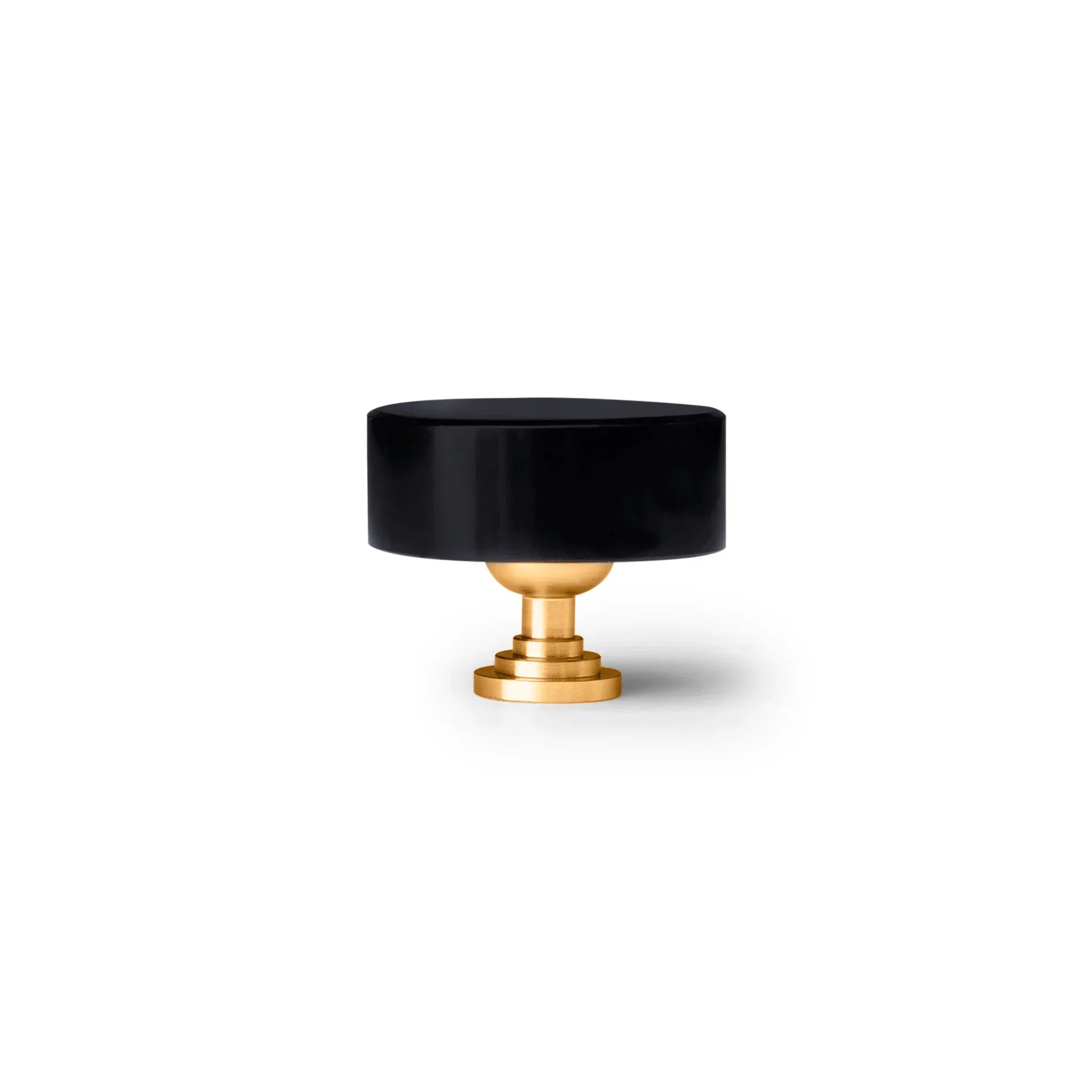 The Mantara M-0001 Theo Knob is a modern marble and brass knob in black, ideal for doors, drawers, and cabinets.