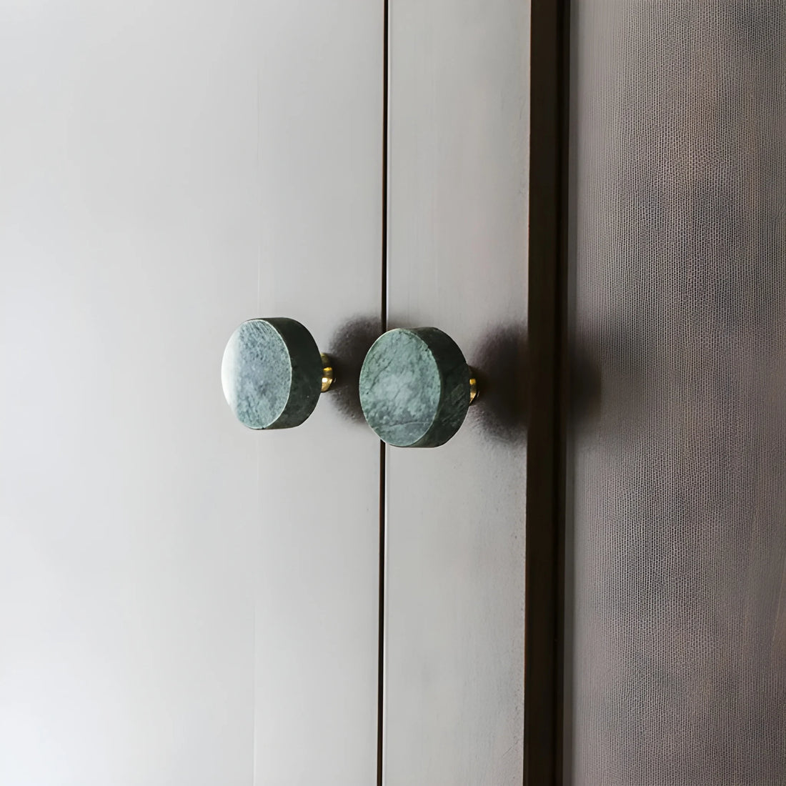 The Mantara M-0001 Theo Knob is a modern marble and brass knob in green, ideal for doors, drawers, and cabinets.
