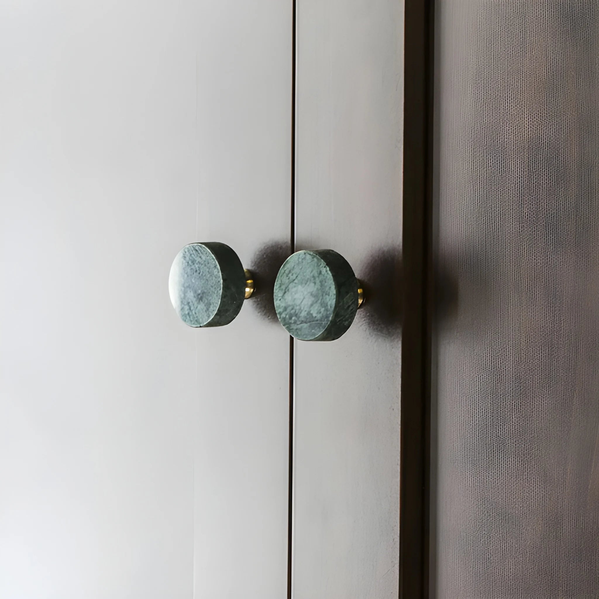 The Mantara M-0001 Theo Knob is a modern marble and brass knob in green, ideal for doors, drawers, and cabinets.