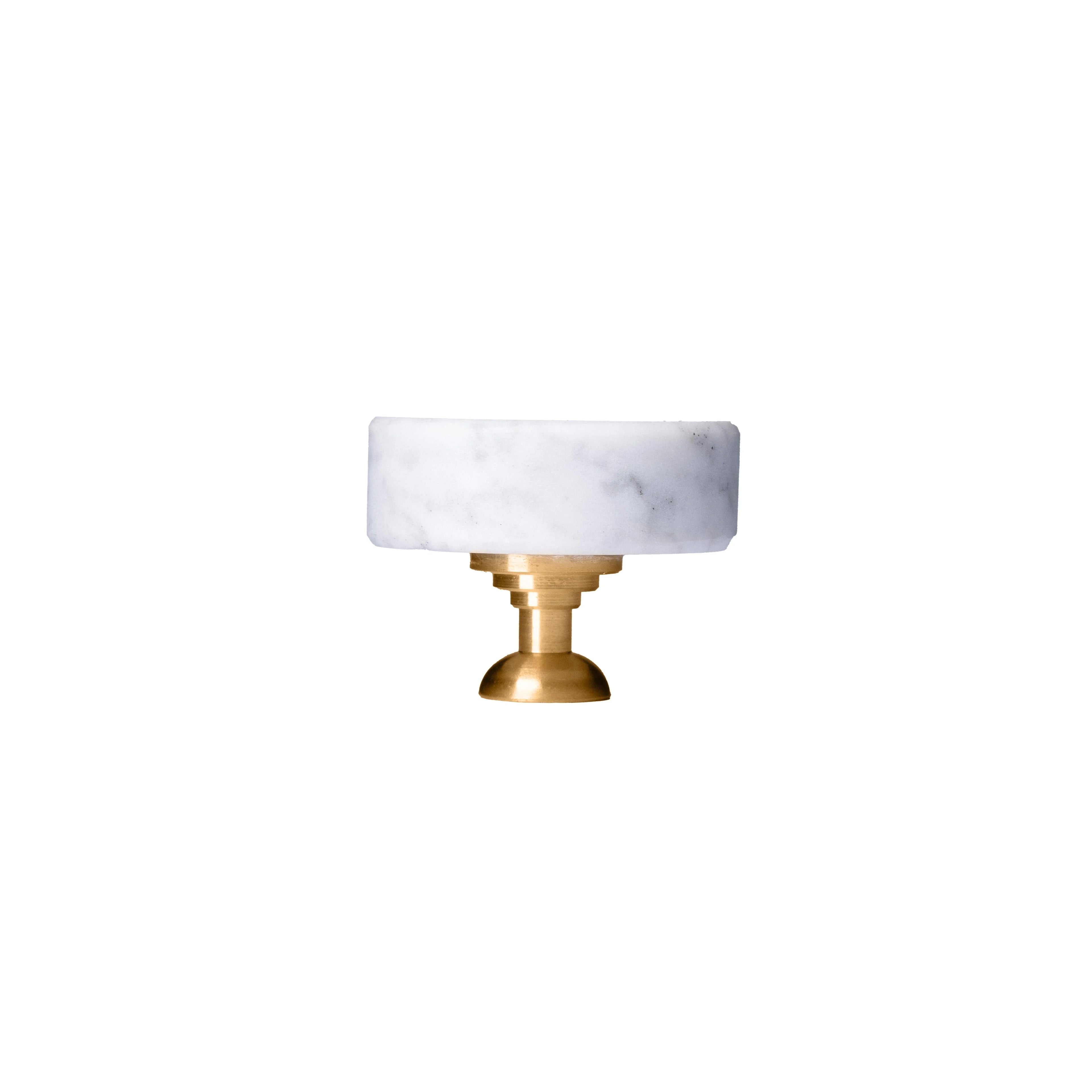 The Mantara M-0001 Theo Knob is a modern marble and brass knob in white, ideal for doors, drawers, and cabinets.