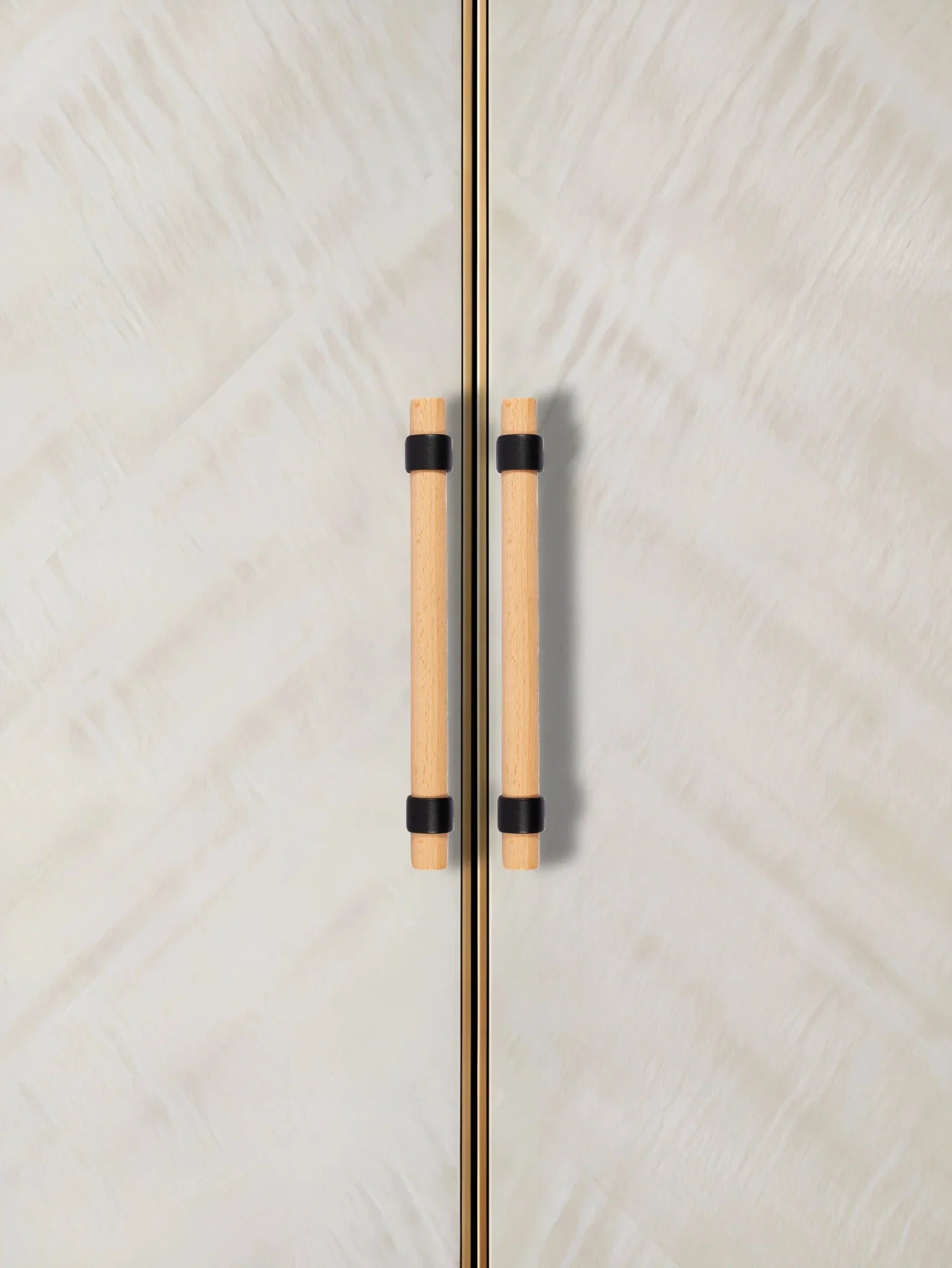 Close-up of a door with wooden handles, set against a textured white background—natural warmth meets simplicity by Mantara.